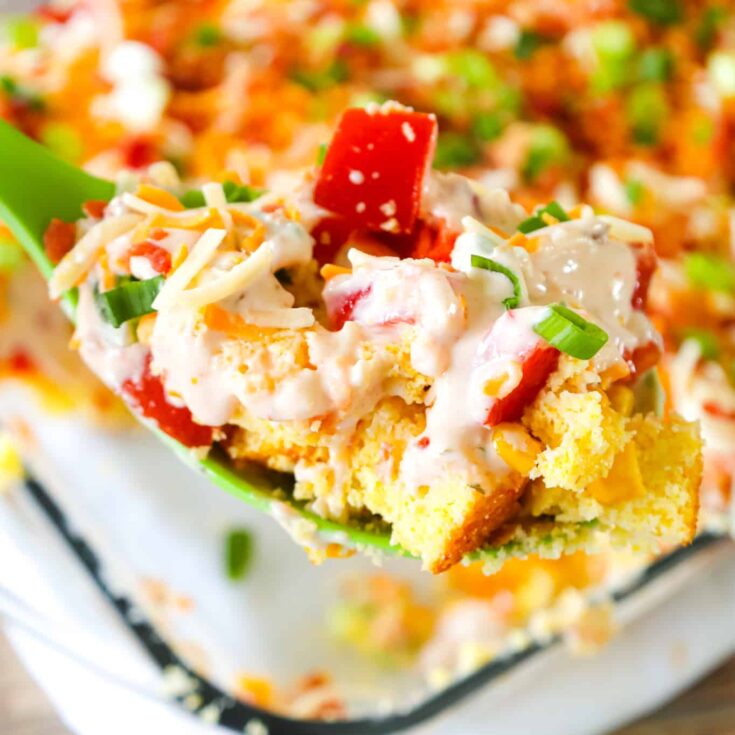 Cornbread Salad is a tasty side dish recipe loaded with cornbread pieces, diced tomatoes, diced bell peppers, corn, shredded cheese, chopped green onions, crumbled bacon and a dressing made from sour cream, ranch and salsa.