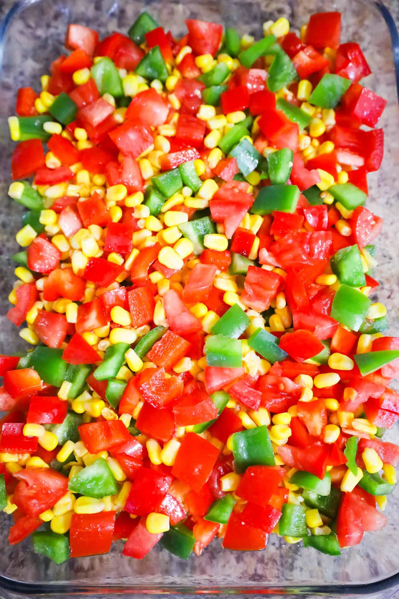 vegetable mixture on top of cornbread in a baking dish