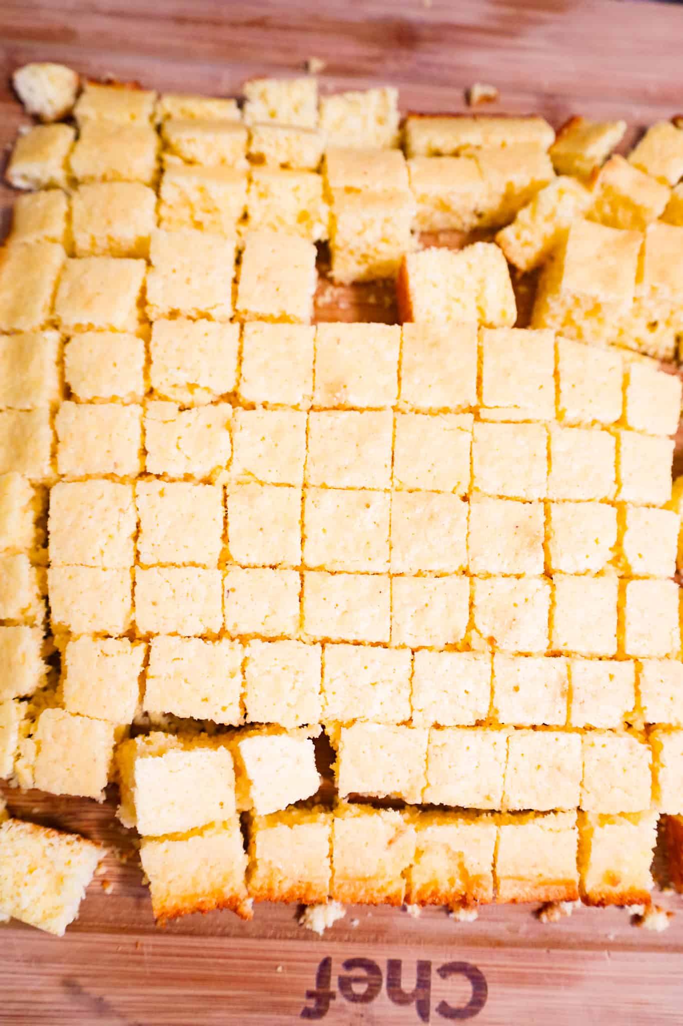 cornbread cut into small cubes on a cutting board