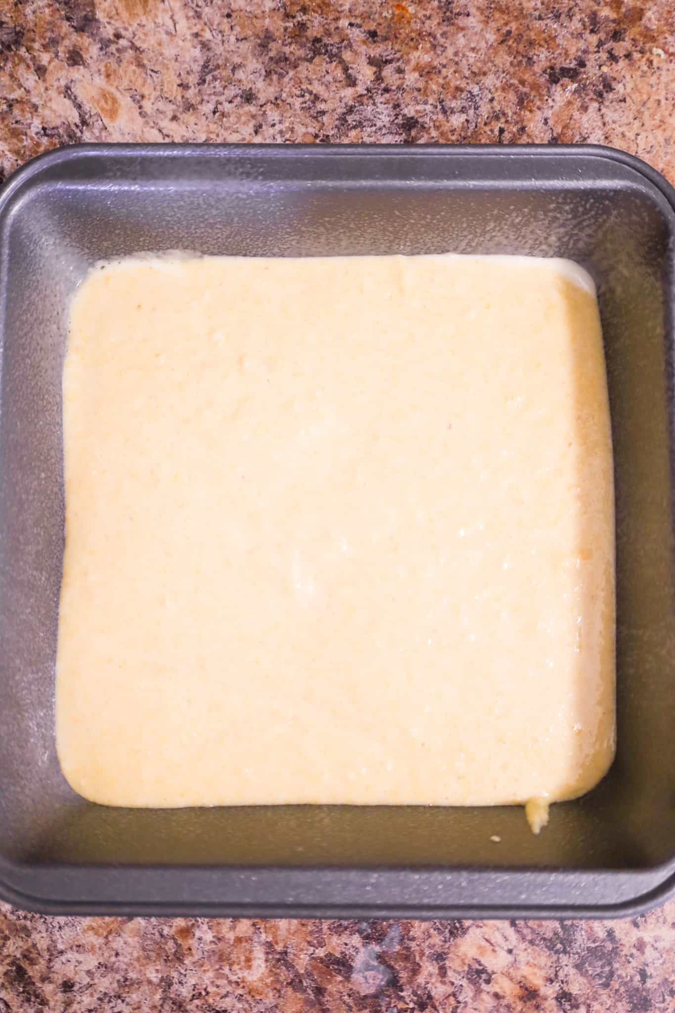 cornbread batter in a cake pan