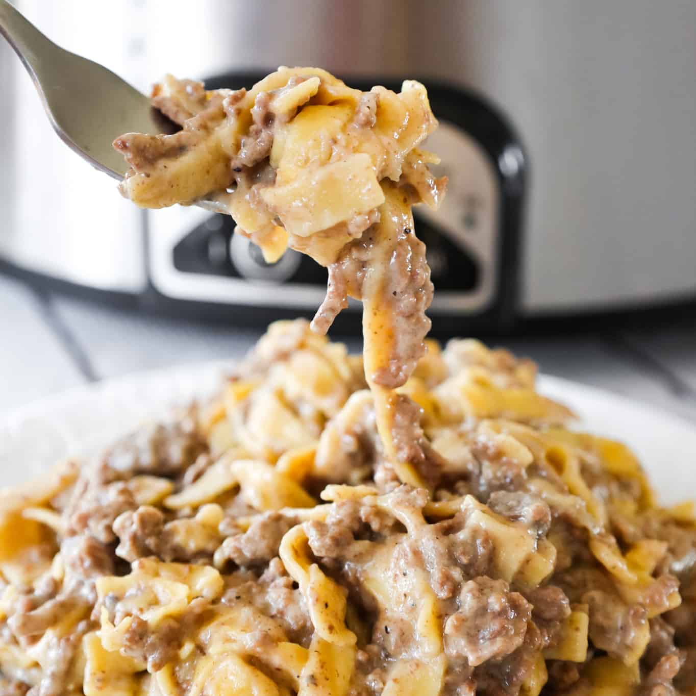 Crock Pot Beef and Noodles is an easy slow cooker dinner recipe loaded with ground beef and egg noodles cooked in a sauce made from beef broth and cream of mushroom soup.