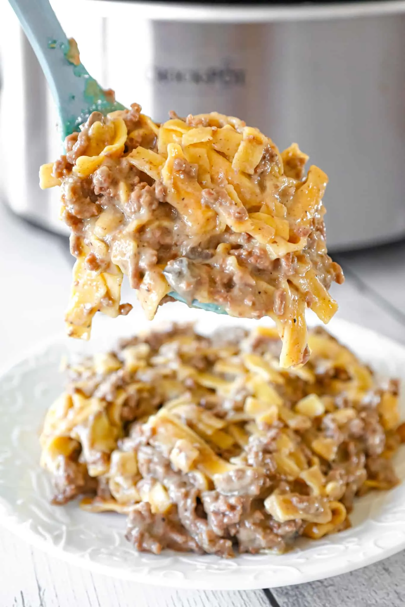 Crock Pot Beef and Noodles is an easy slow cooker dinner recipe loaded with ground beef and egg noodles cooked in a sauce made from beef broth and cream of mushroom soup.