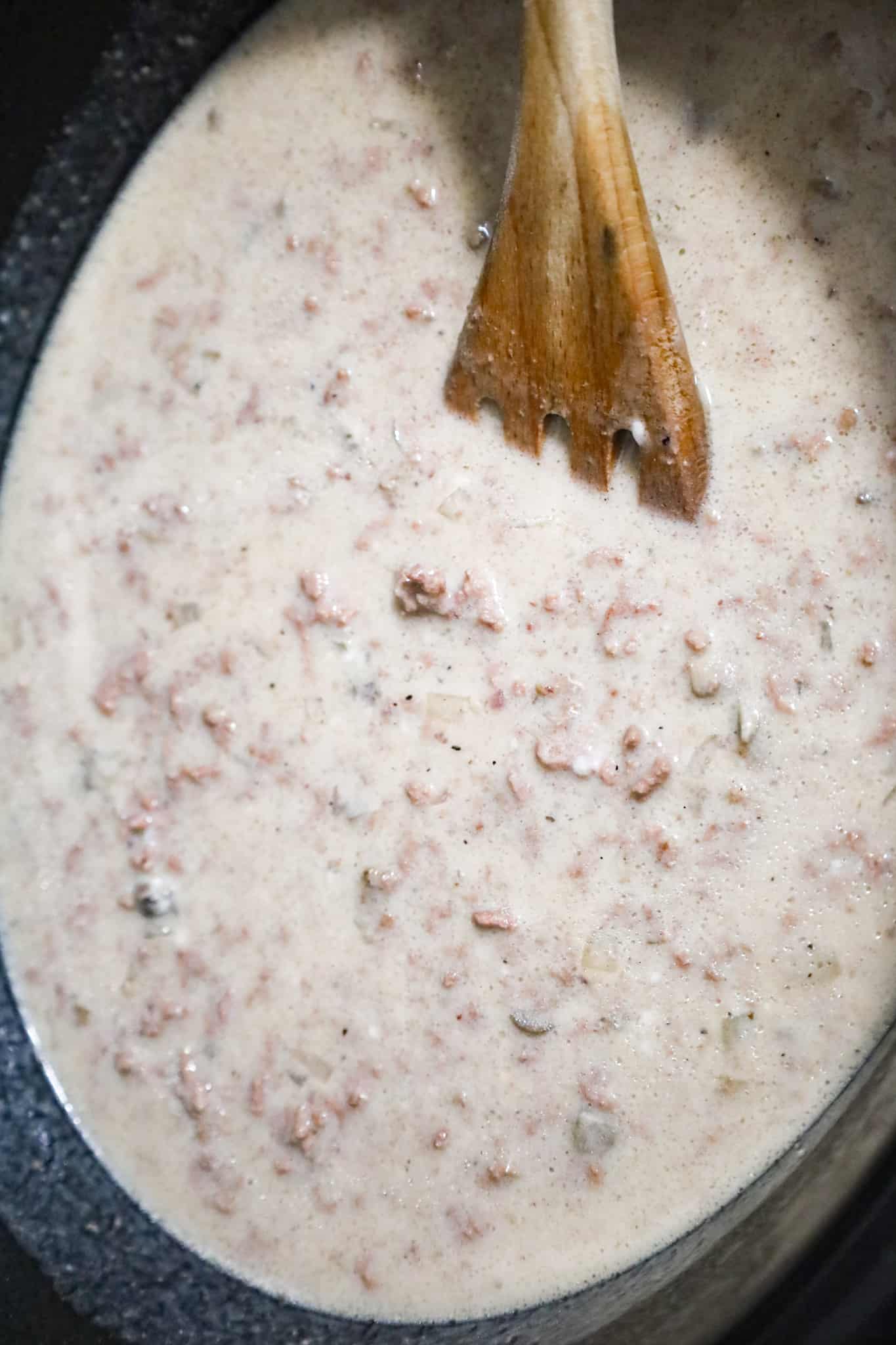 ground beef, cream of mushroom soup and beef broth mixture in a crock pot