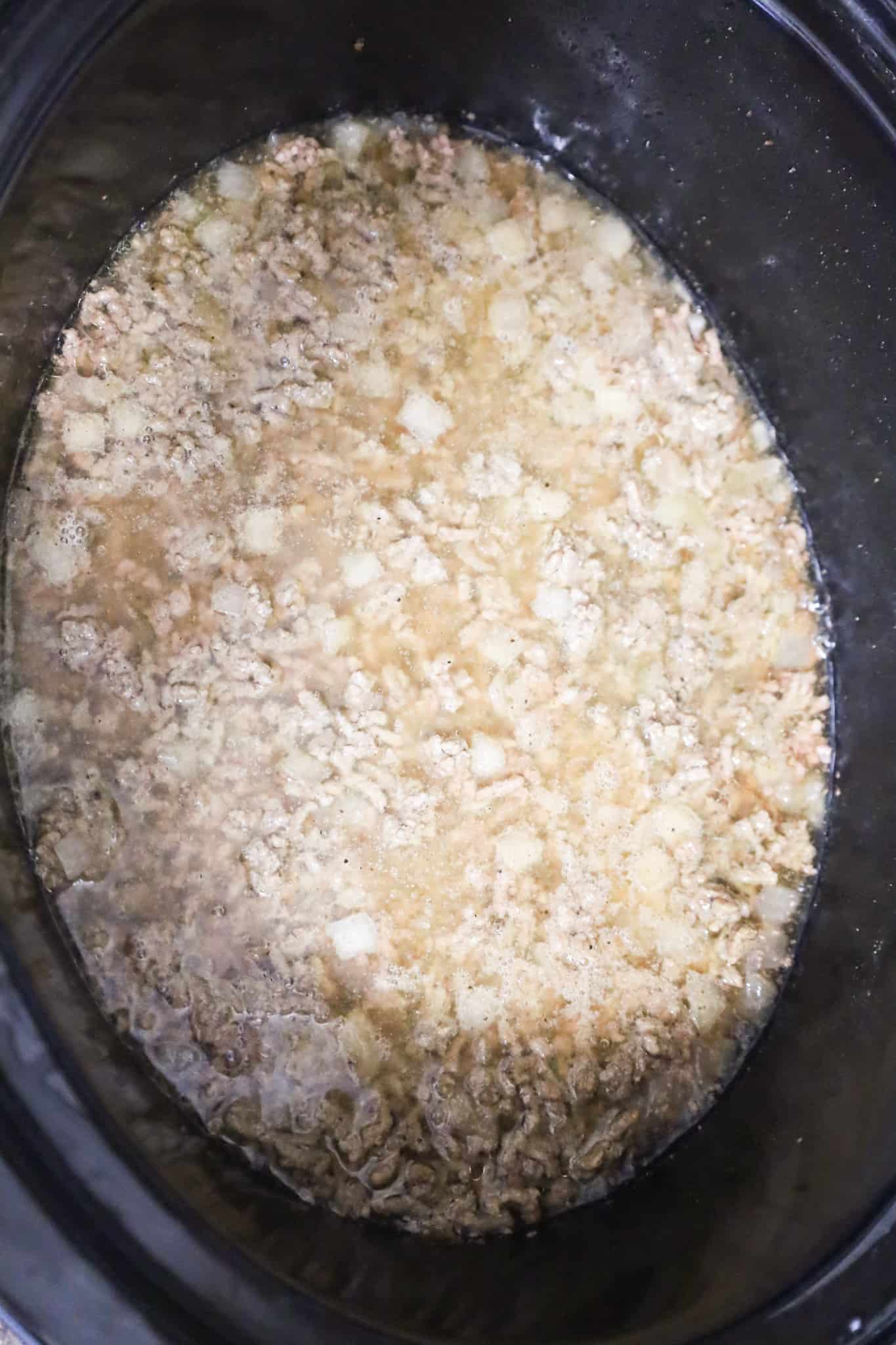 beef broth and cooked ground beef in a crock pot