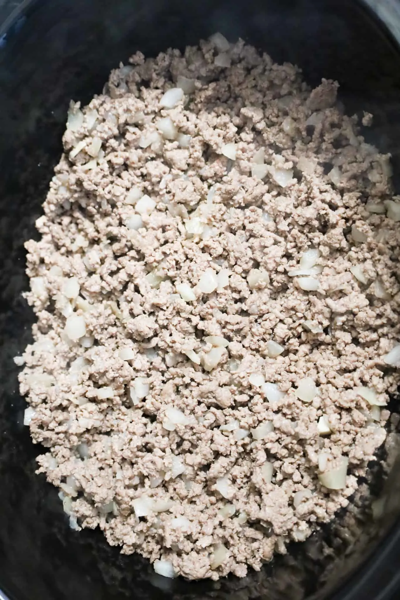 cooked ground beef in a crock pot