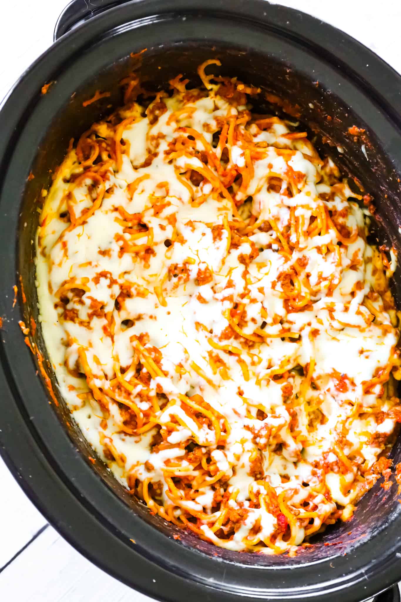 Crock Pot Spaghetti is a hearty slow cooker pasta recipe loaded with ground beef, marinara sauce and cheese.