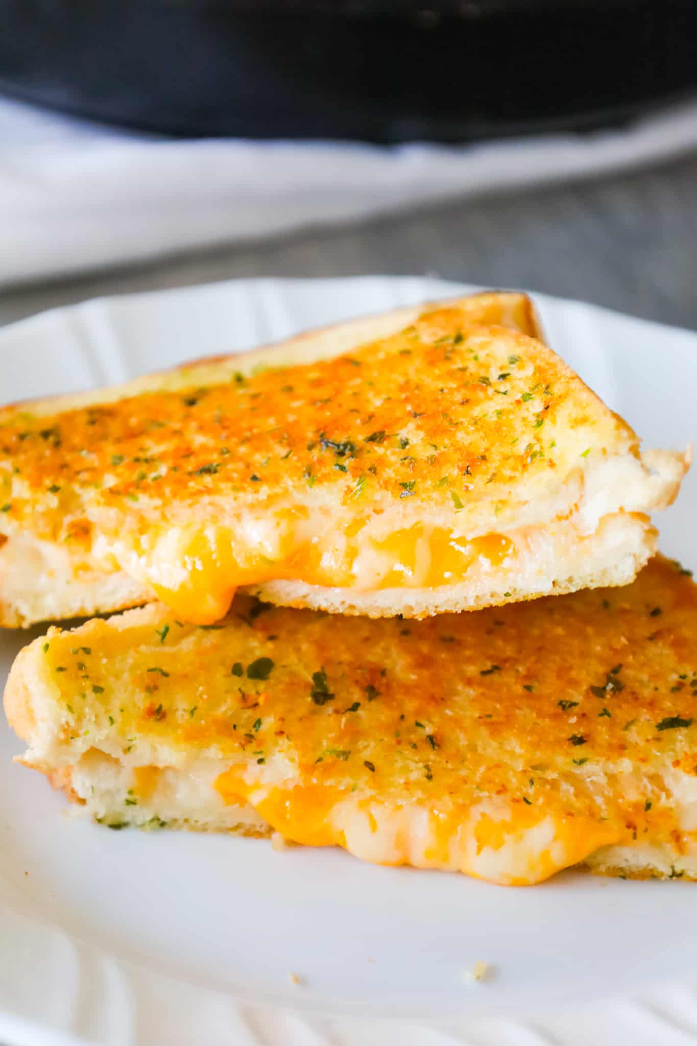 Garlic Bread Grilled Cheese is an easy lunch or dinner recipe with garlic buttered bread filled with gooey mozzarella and cheddar cheese.