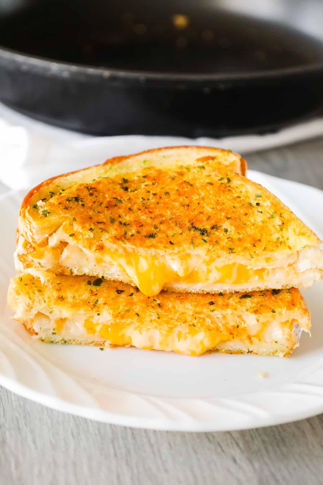 Garlic Bread Grilled Cheese is an easy lunch or dinner recipe with garlic buttered bread filled with gooey mozzarella and cheddar cheese.
