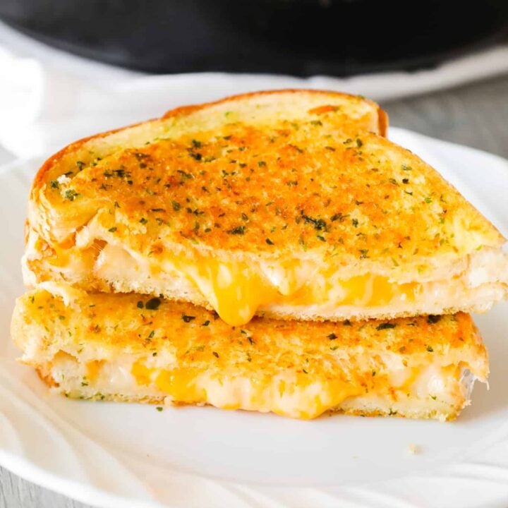 Garlic Bread Grilled Cheese is an easy lunch or dinner recipe with garlic buttered bread filled with gooey mozzarella and cheddar cheese.