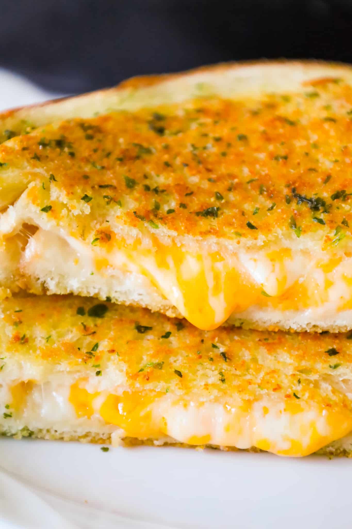 Garlic Bread Grilled Cheese is an easy lunch or dinner recipe with garlic buttered bread filled with gooey mozzarella and cheddar cheese.