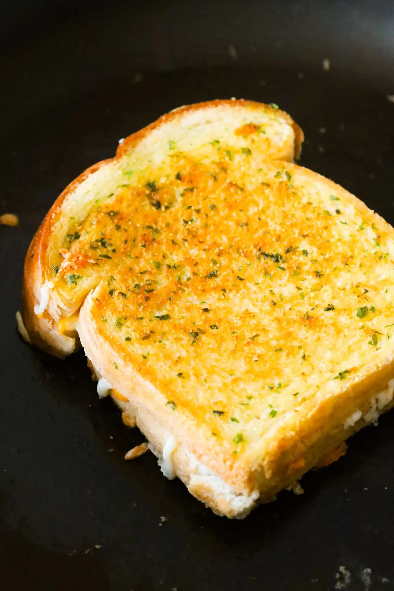 Garlic Bread Grilled Cheese is an easy lunch or dinner recipe with garlic buttered bread filled with gooey mozzarella and cheddar cheese.