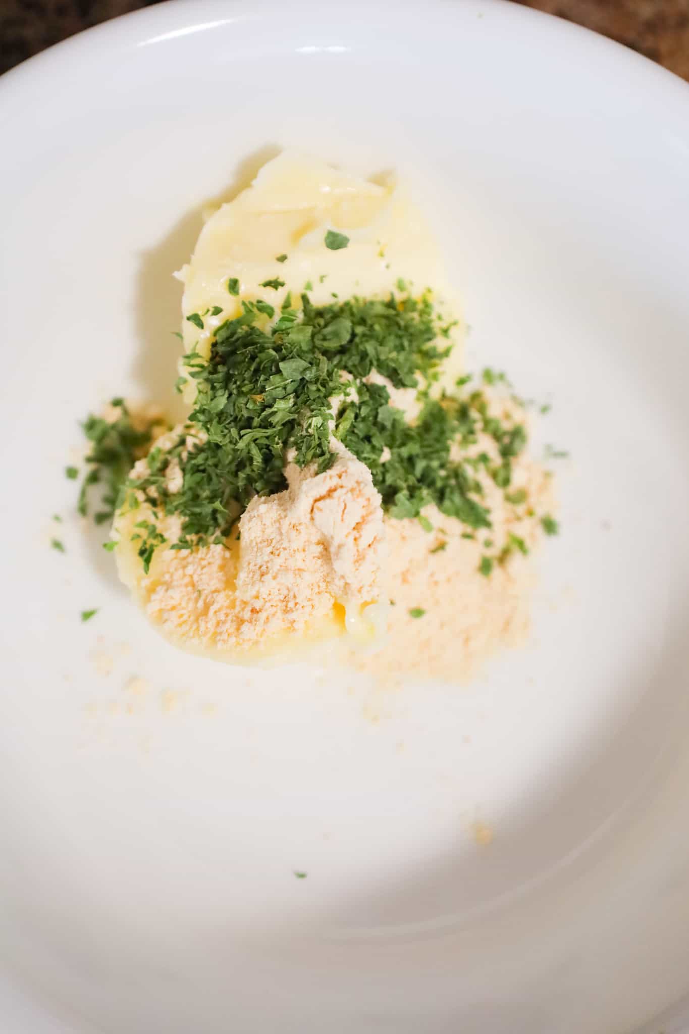 garlic powder, dried parsley and softened butter in a mixing bowl