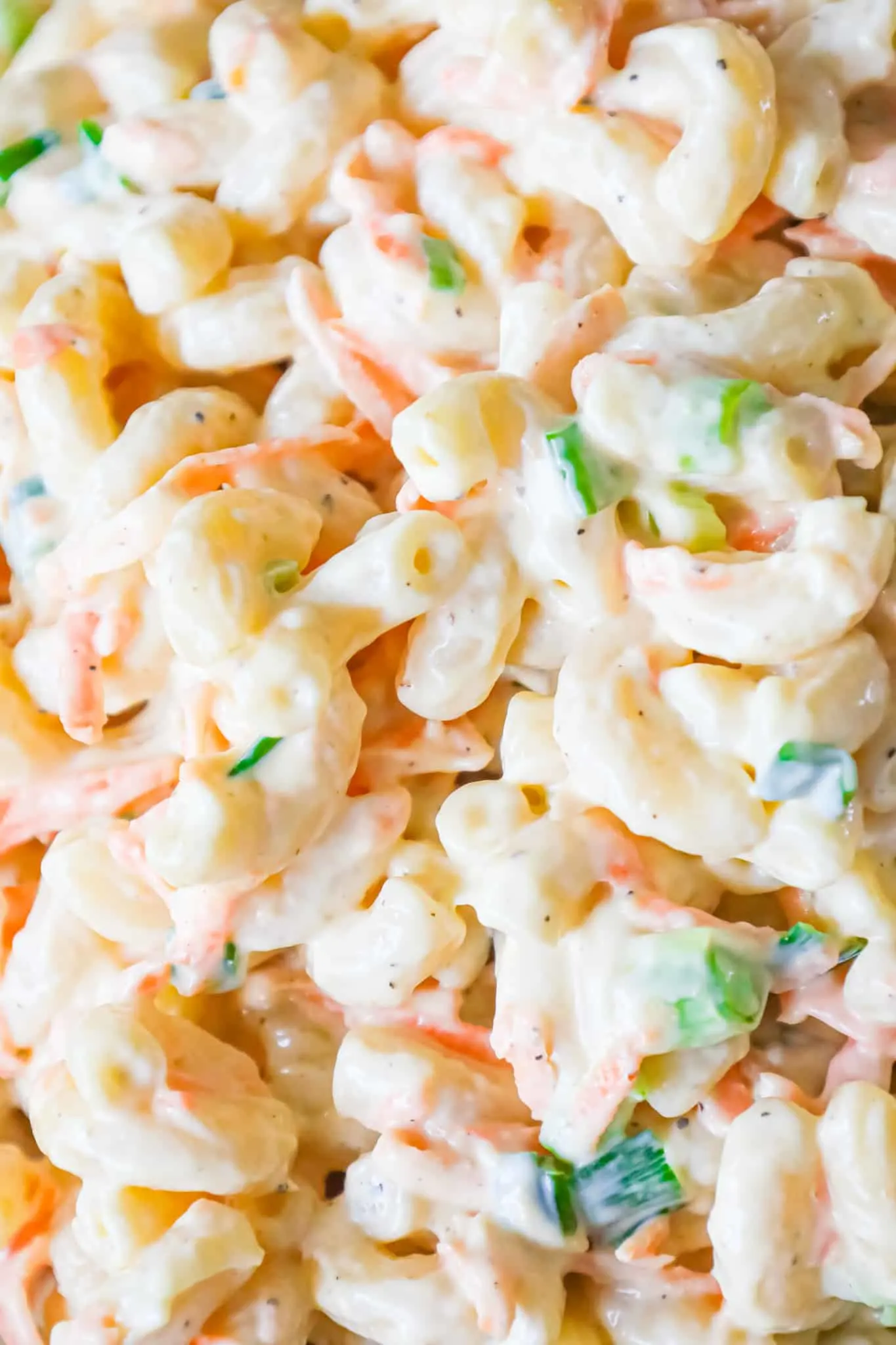 Hawaiian Macaroni Salad is a creamy pasta salad recipe loaded with grated carrots, yellow onion and chopped green onion.