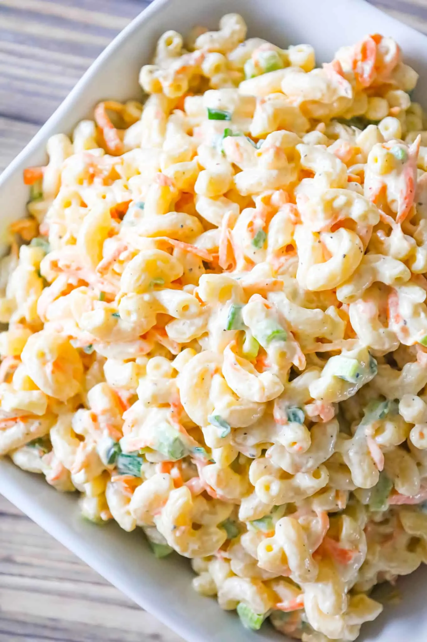 Hawaiian Macaroni Salad is a creamy pasta salad recipe loaded with grated carrots, yellow onion and chopped green onion.