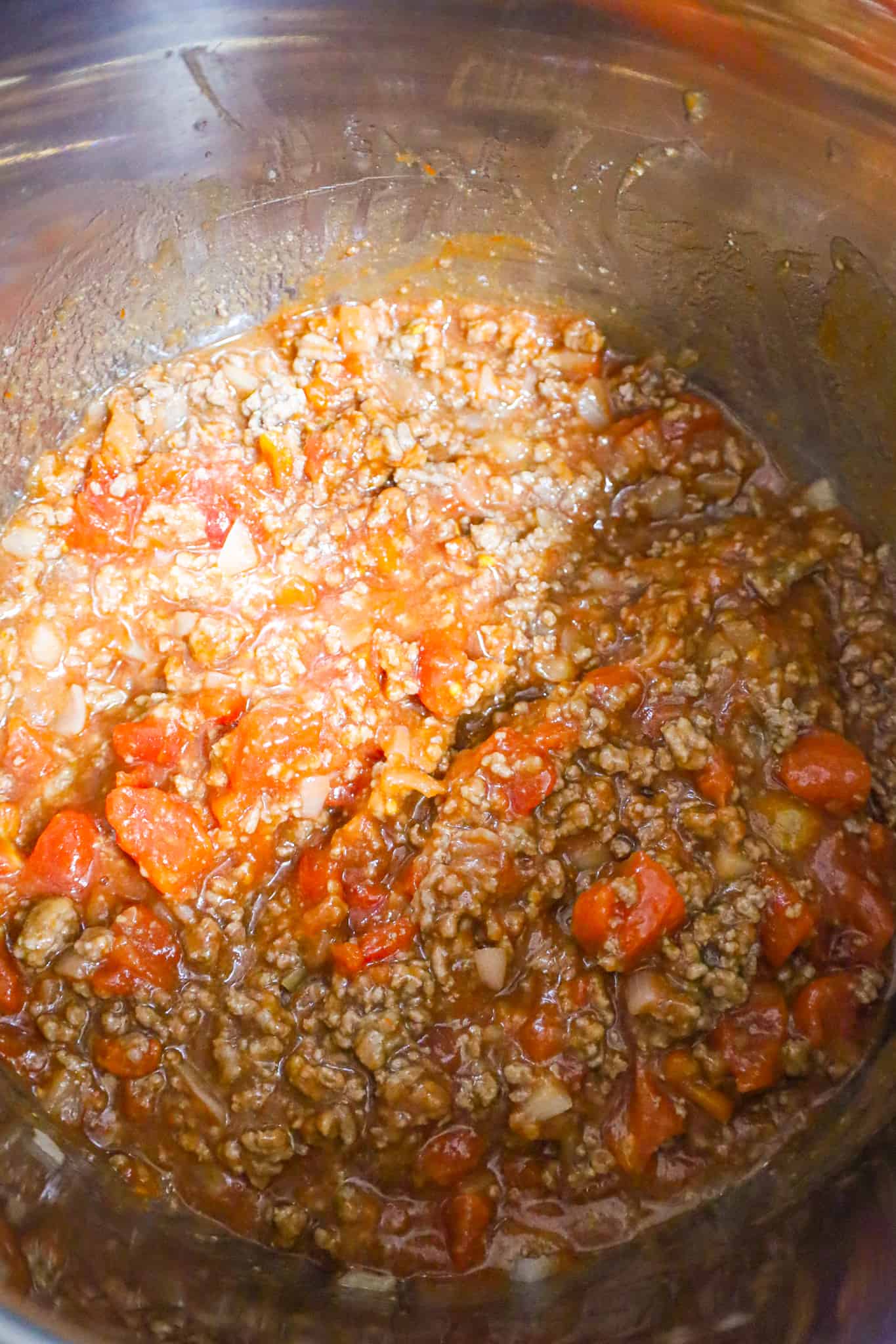 cooked ground beef, diced onions and sloppy joe sauce all mixed together in an Instant Pot