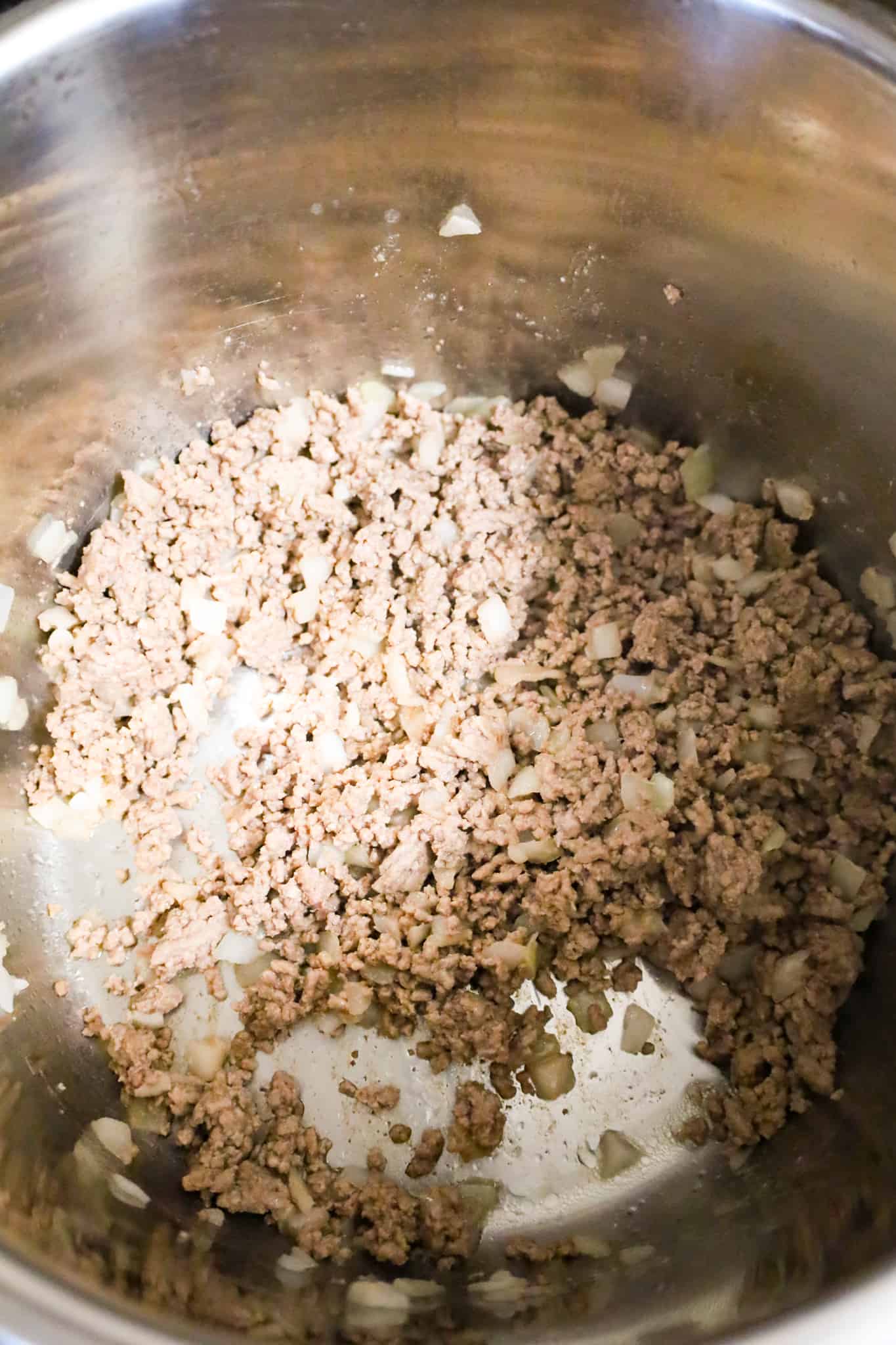 cooked ground beef and diced onions in an Instant Pot