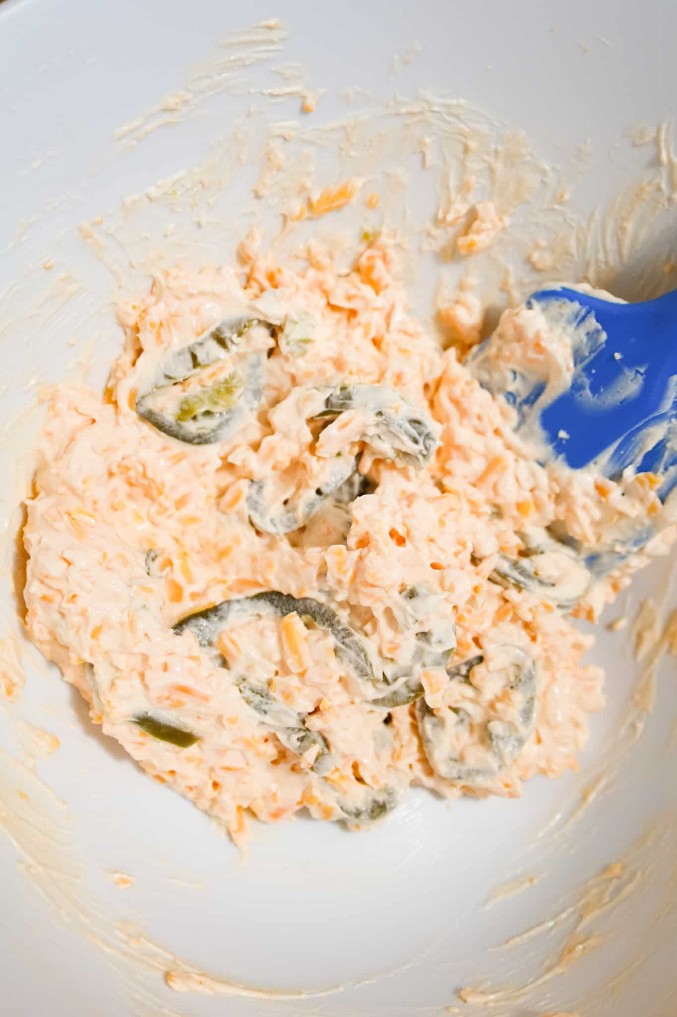 cream cheese, cheddar cheese and jalapeno mixture in a mixing bowl