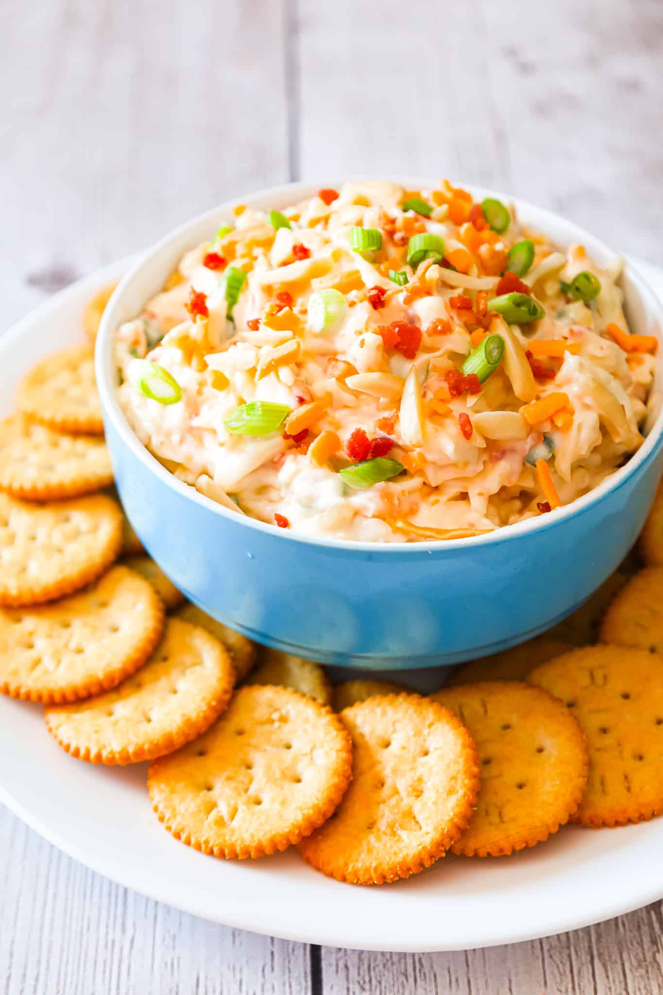 Million Dollar Dip is a delicious cold party dip recipe loaded with crumbled bacon, slivered almonds, chopped green onions, mayo, parmesan, mozzarella and cheddar cheese.