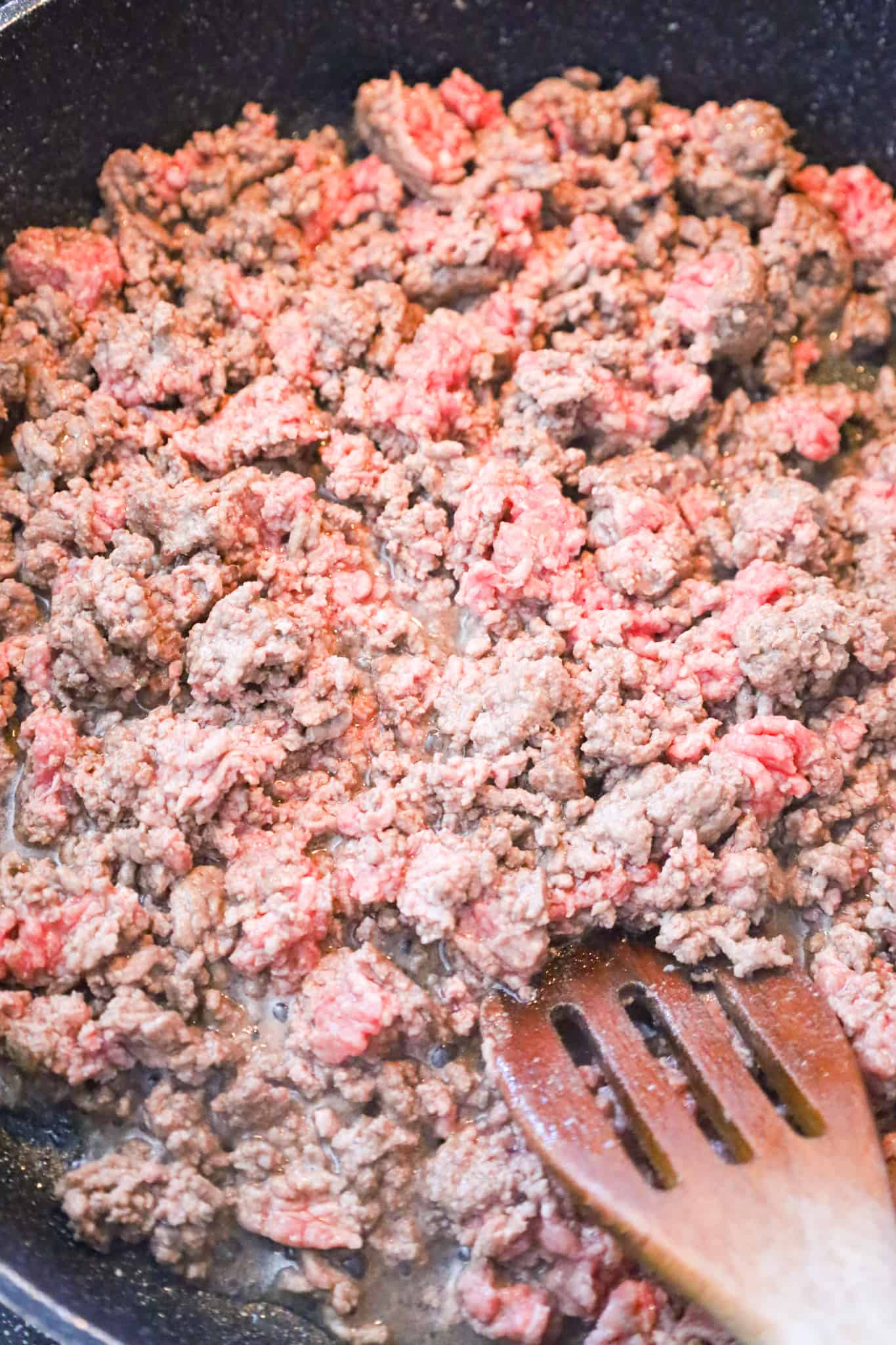 ground beef cooking in a saute pan