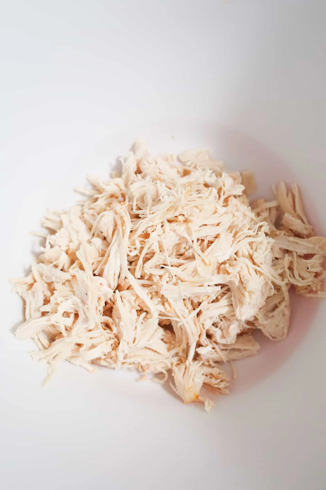 shredded chicken in a mixing bowl