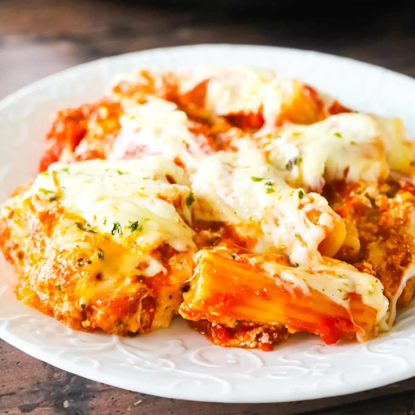 Crock Pot Baked Ziti is a delicious slow cooker pasta recipe loaded with marinara sauce, ricotta, sour cream, basil pesto, parmesan and mozzarella cheese.