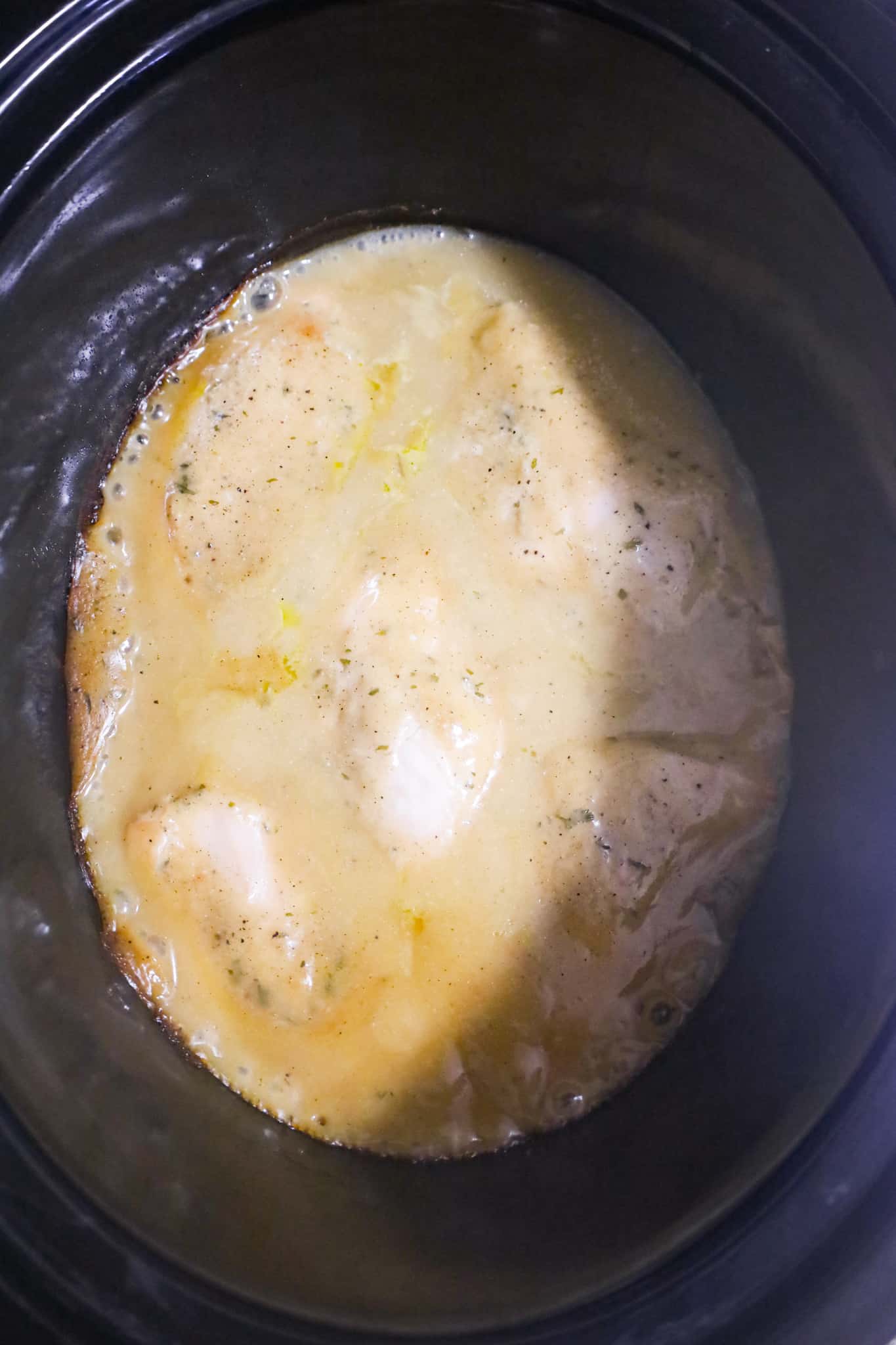 chicken breasts and gravy in a crock pot after cooking