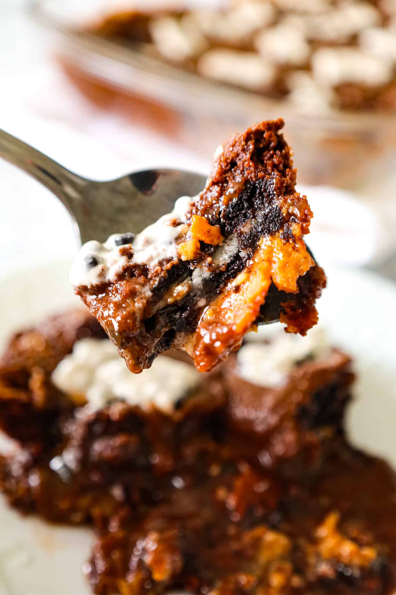 Oreo Dump Cake is an easy and decadent dessert recipe using Oreo cookies, white frosting, chocolate cake mix, sweetened condensed milk and butter.
