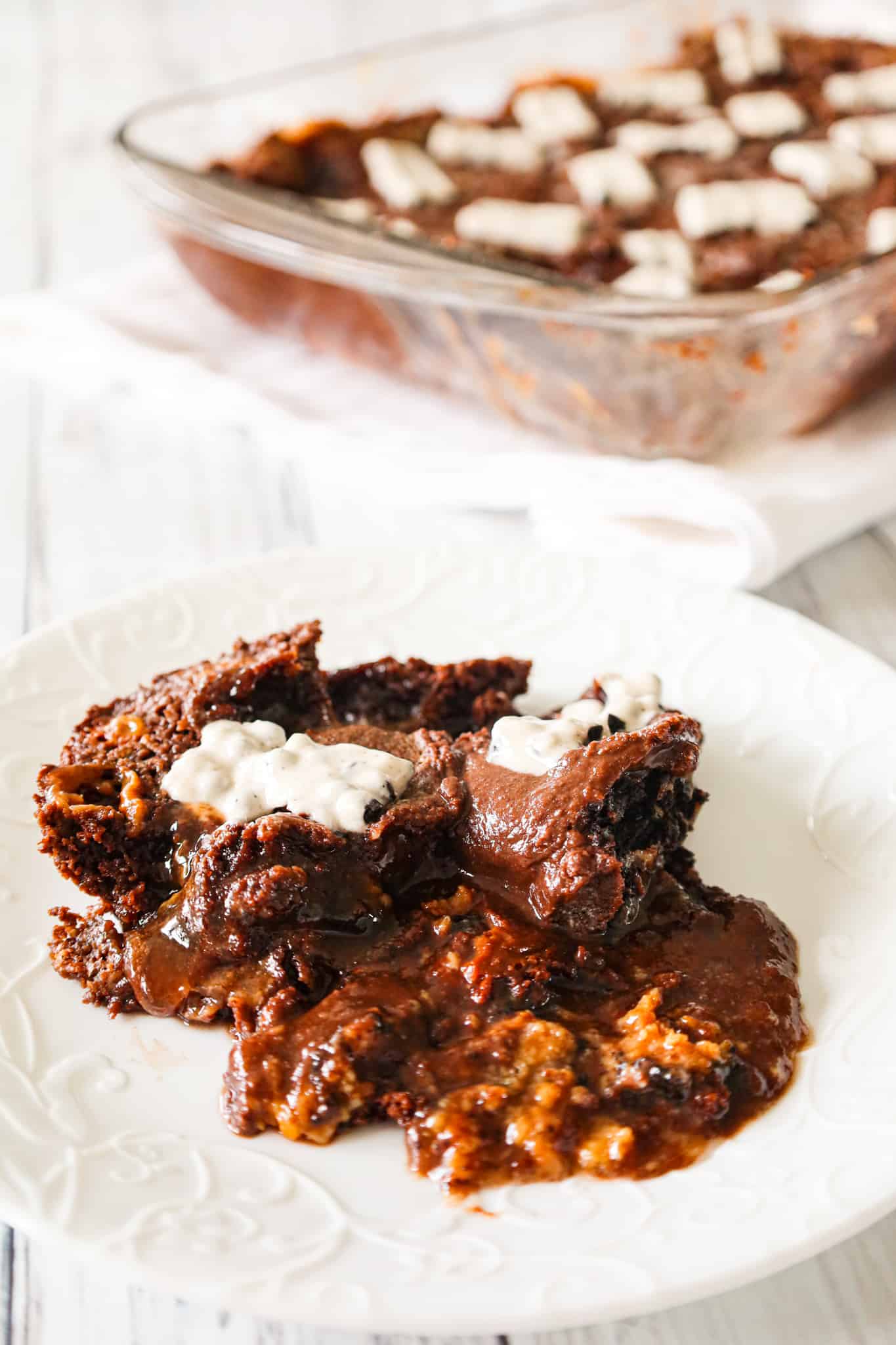 Oreo Dump Cake is an easy and decadent dessert recipe using Oreo cookies, white frosting, chocolate cake mix, sweetened condensed milk and butter.