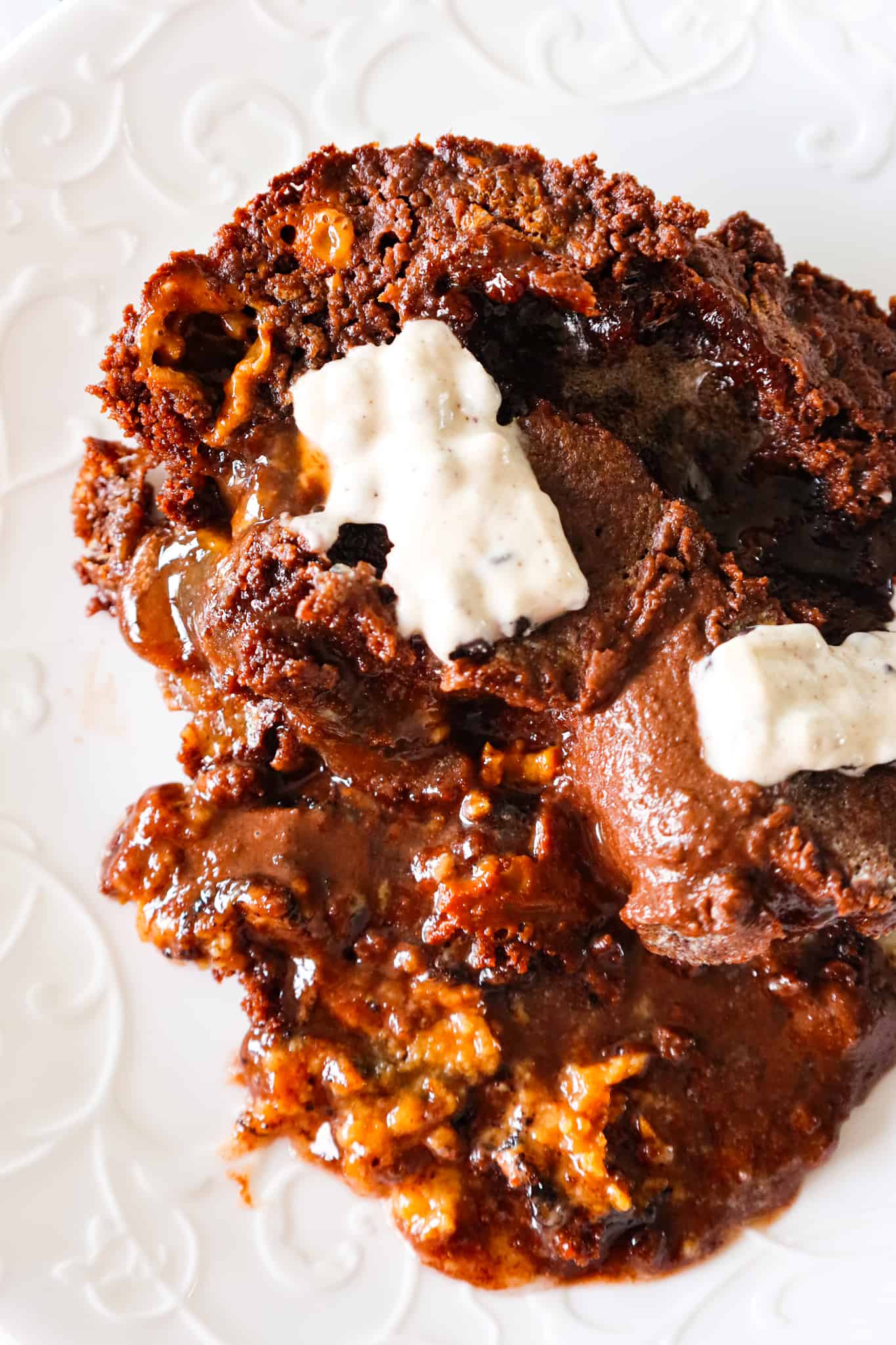 Oreo Dump Cake is an easy and decadent dessert recipe using Oreo cookies, white frosting, chocolate cake mix, sweetened condensed milk and butter.