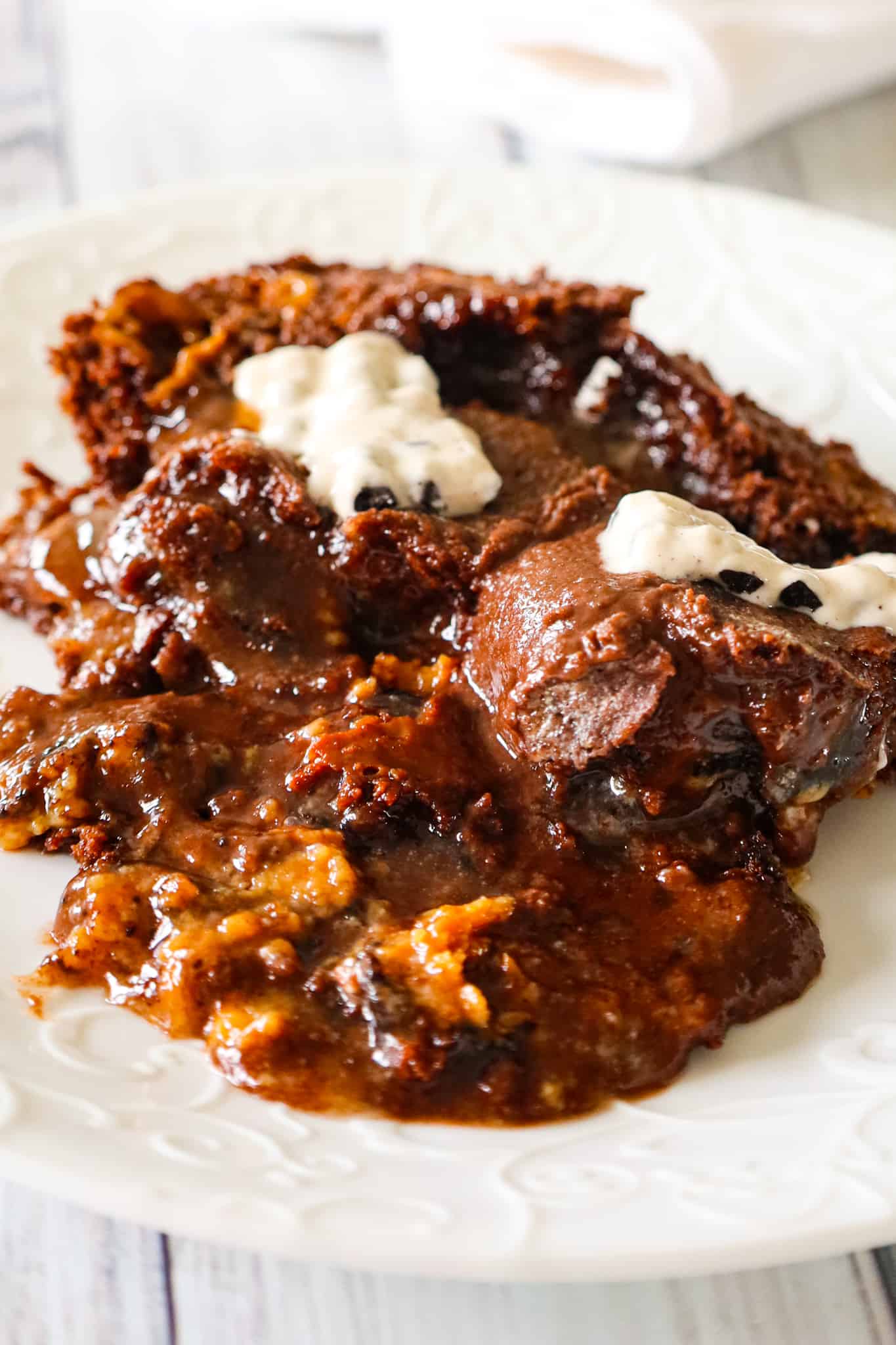 Oreo Dump Cake is an easy and decadent dessert recipe using Oreo cookies, white frosting, chocolate cake mix, sweetened condensed milk and butter.