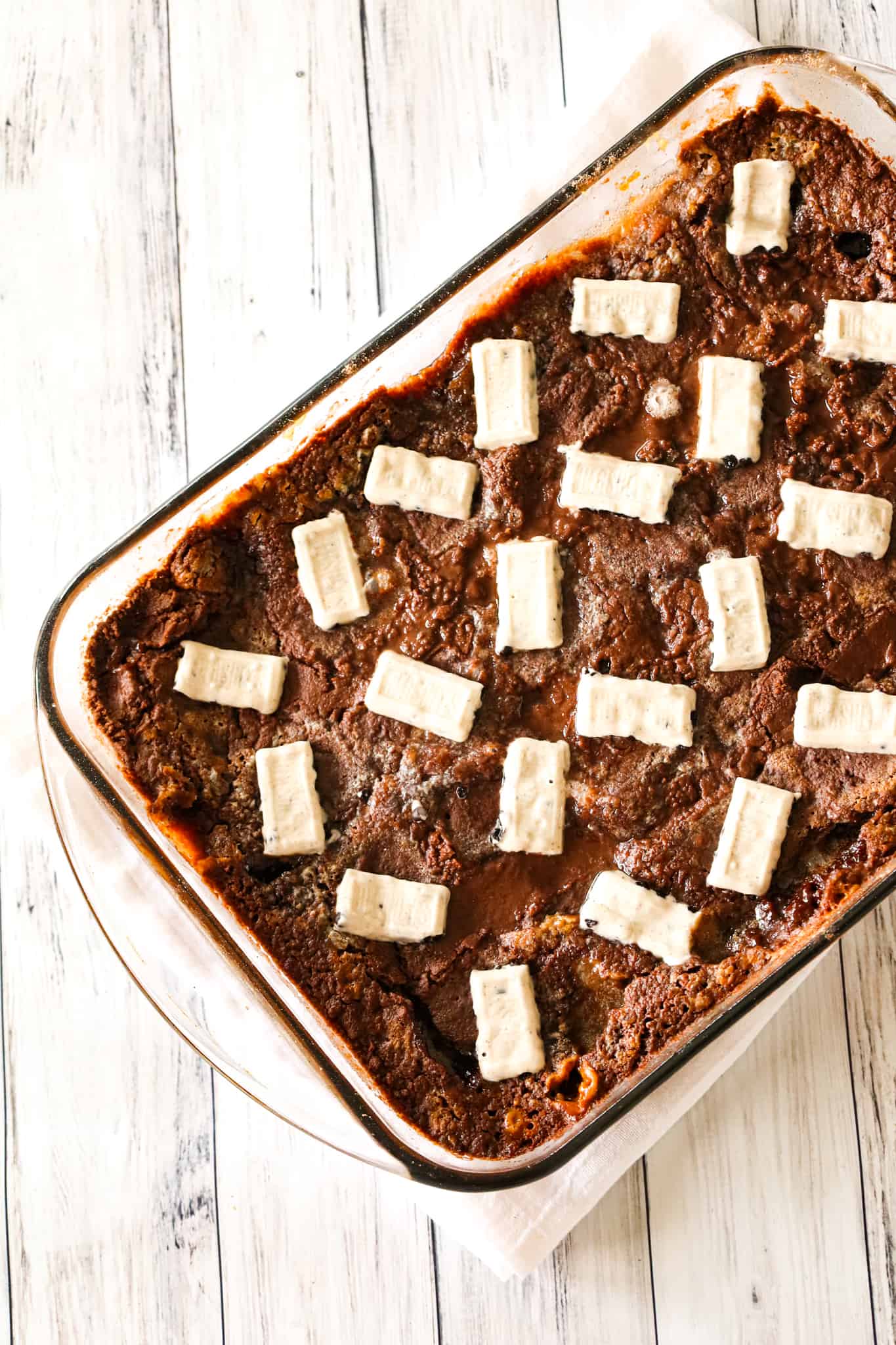 Oreo Dump Cake is an easy and decadent dessert recipe using Oreo cookies, white frosting, chocolate cake mix, sweetened condensed milk and butter.