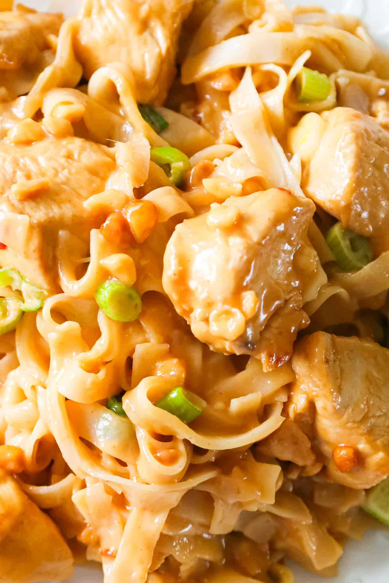 Peanut Butter Chicken is an easy dinner recipe made with boneless, skinless chicken breast chunks and rice stick noodles all tossed in sauce made from coconut milk, soy sauce, lime juice, Thai chili sauce and peanut butter.