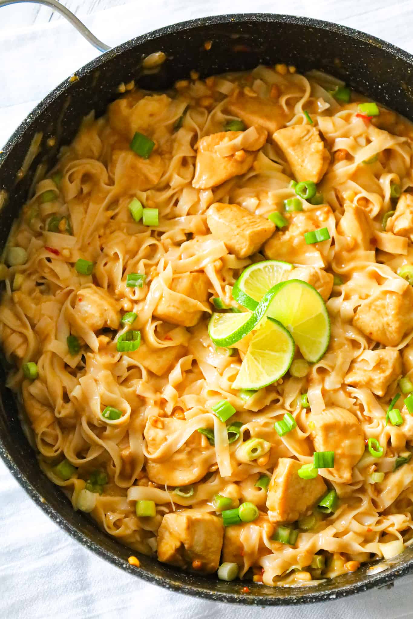 Peanut Butter Chicken is an easy dinner recipe made with boneless, skinless chicken breast chunks and rice stick noodles all tossed in sauce made from coconut milk, soy sauce, lime juice, Thai chili sauce and peanut butter.