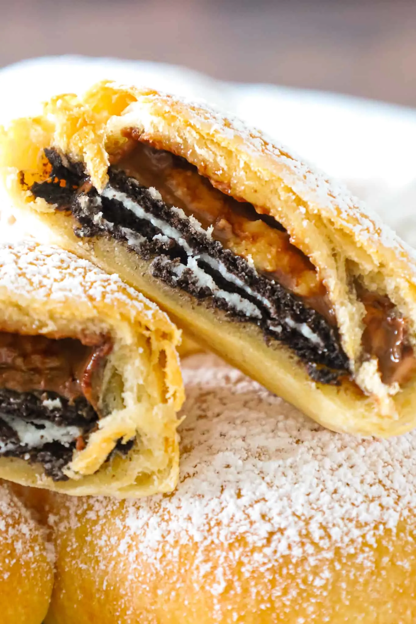 Air Fryer Oreos are a fun twist on deep fried Oreos. These tasty treats are made with Oreo thins and Reese's peanut butter cup thins wrapped in Pillsbury crescent roll dough and air fried until golden brown.