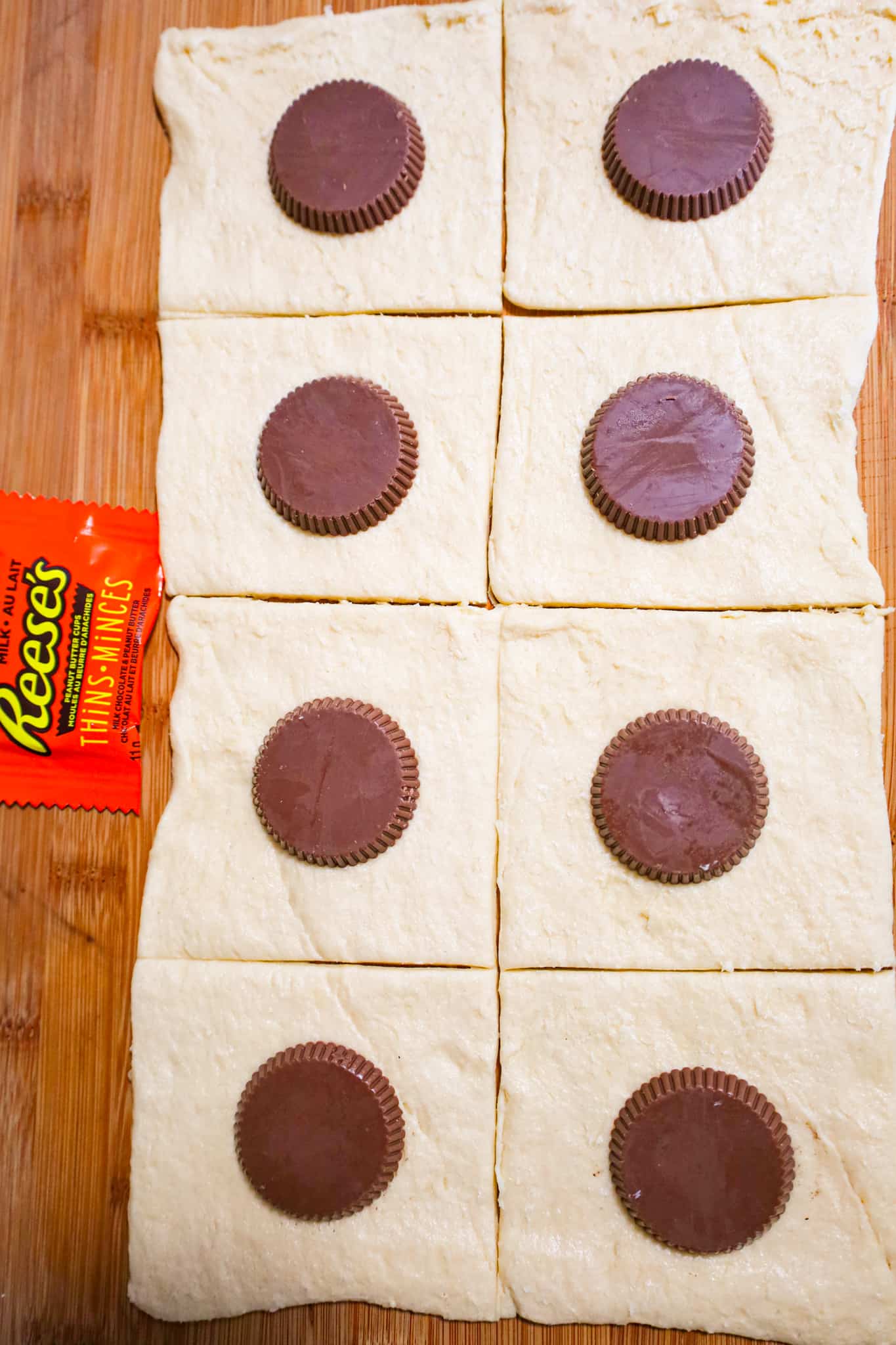 Reese's peanut butter cup thins on top of squares of Pillsbury crescent roll dough