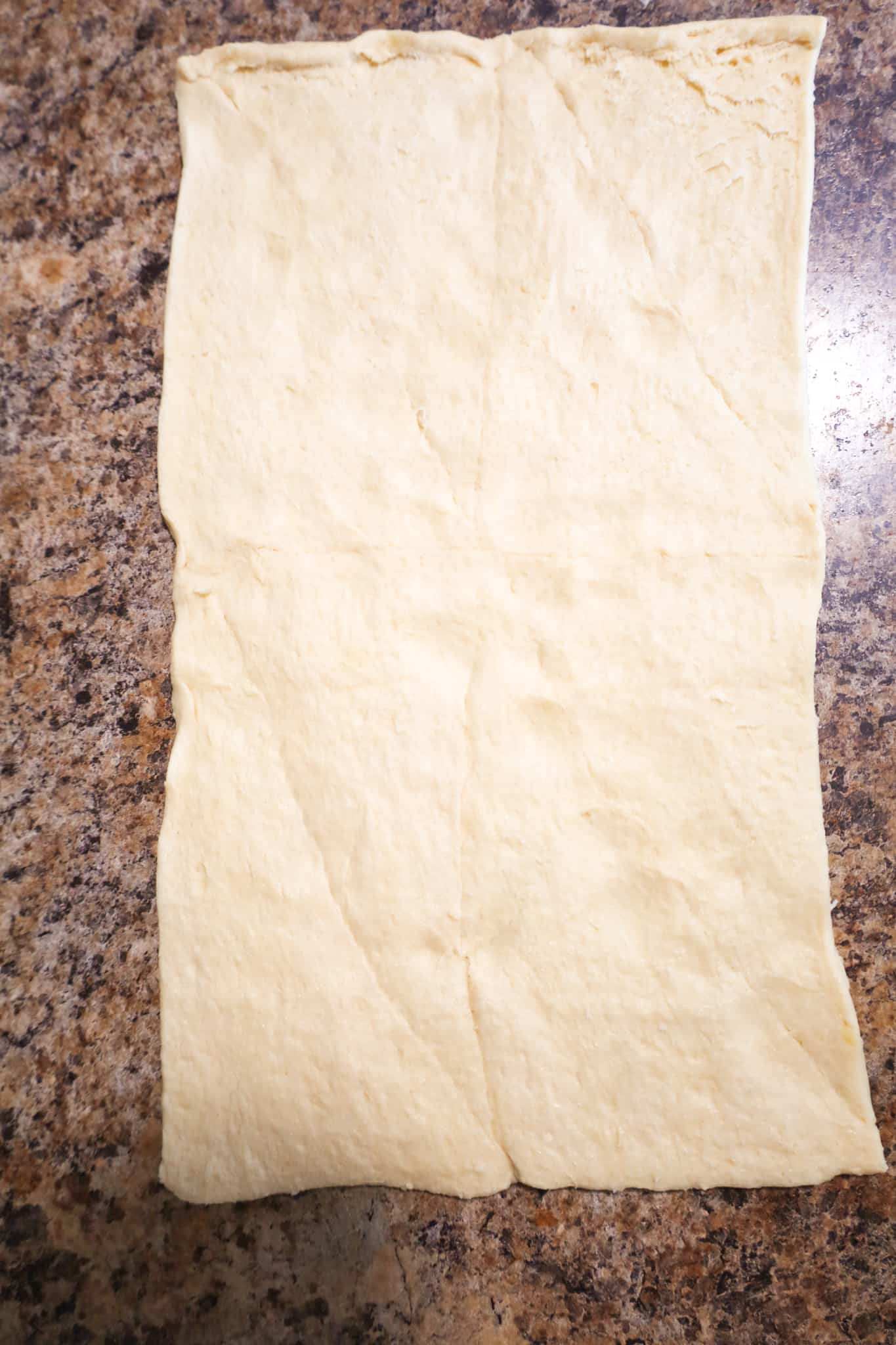sheet of crescent roll dough with the seams pressed together