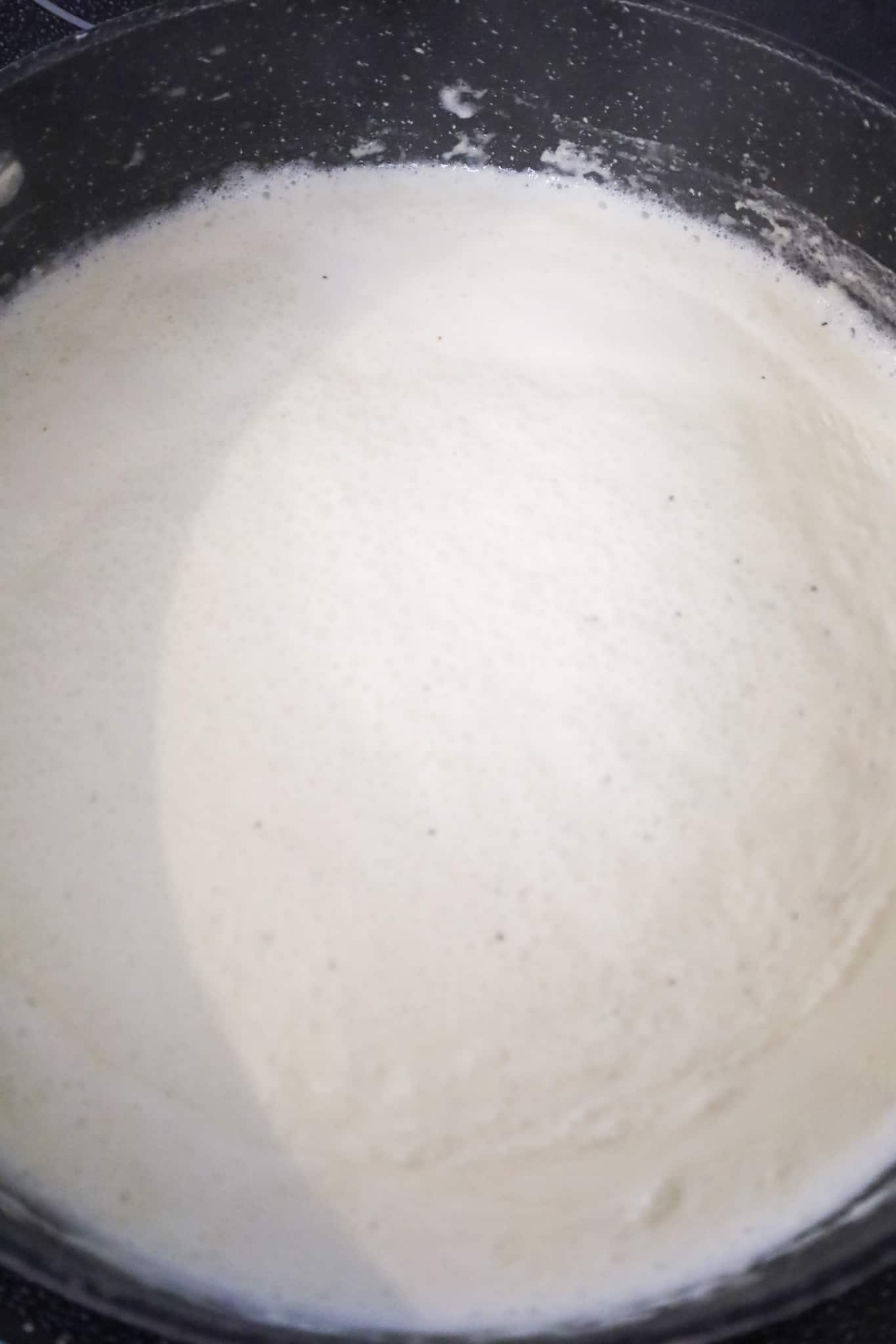 creamy sauce simmering in pan