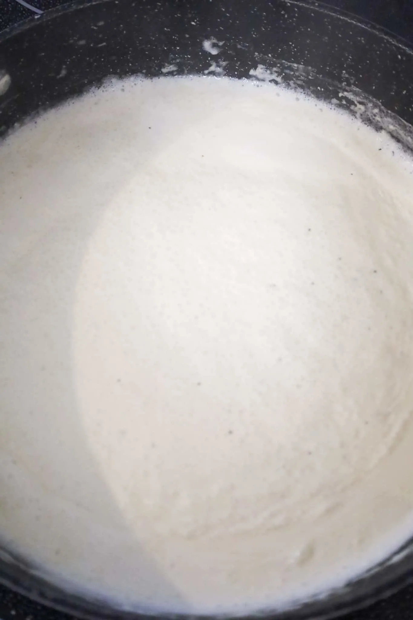 creamy sauce simmering in pan
