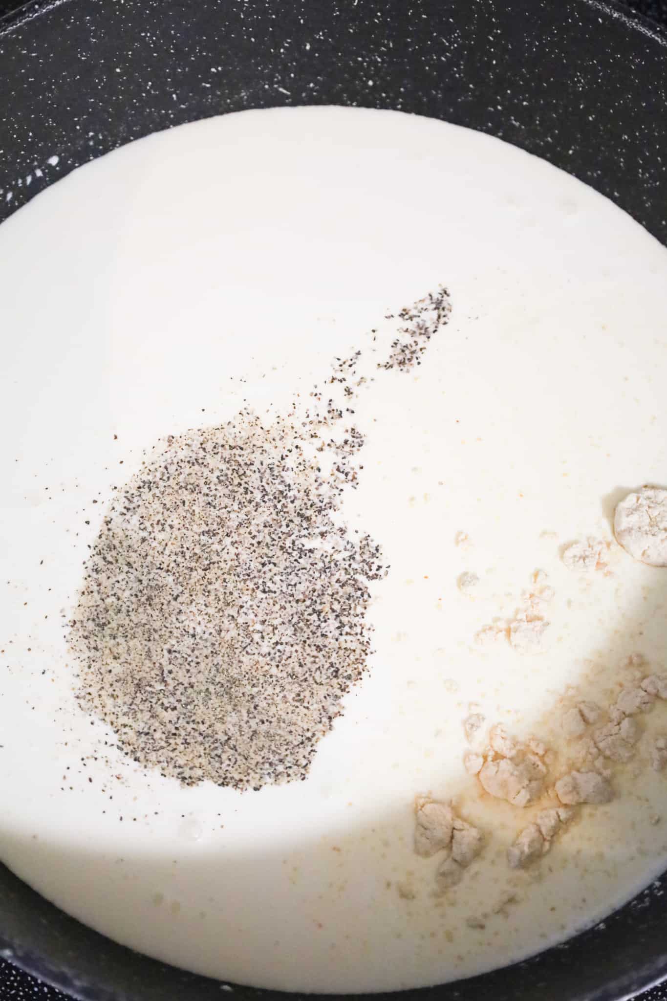 salt, pepper and garlic powder on top of heavy cream in a pot