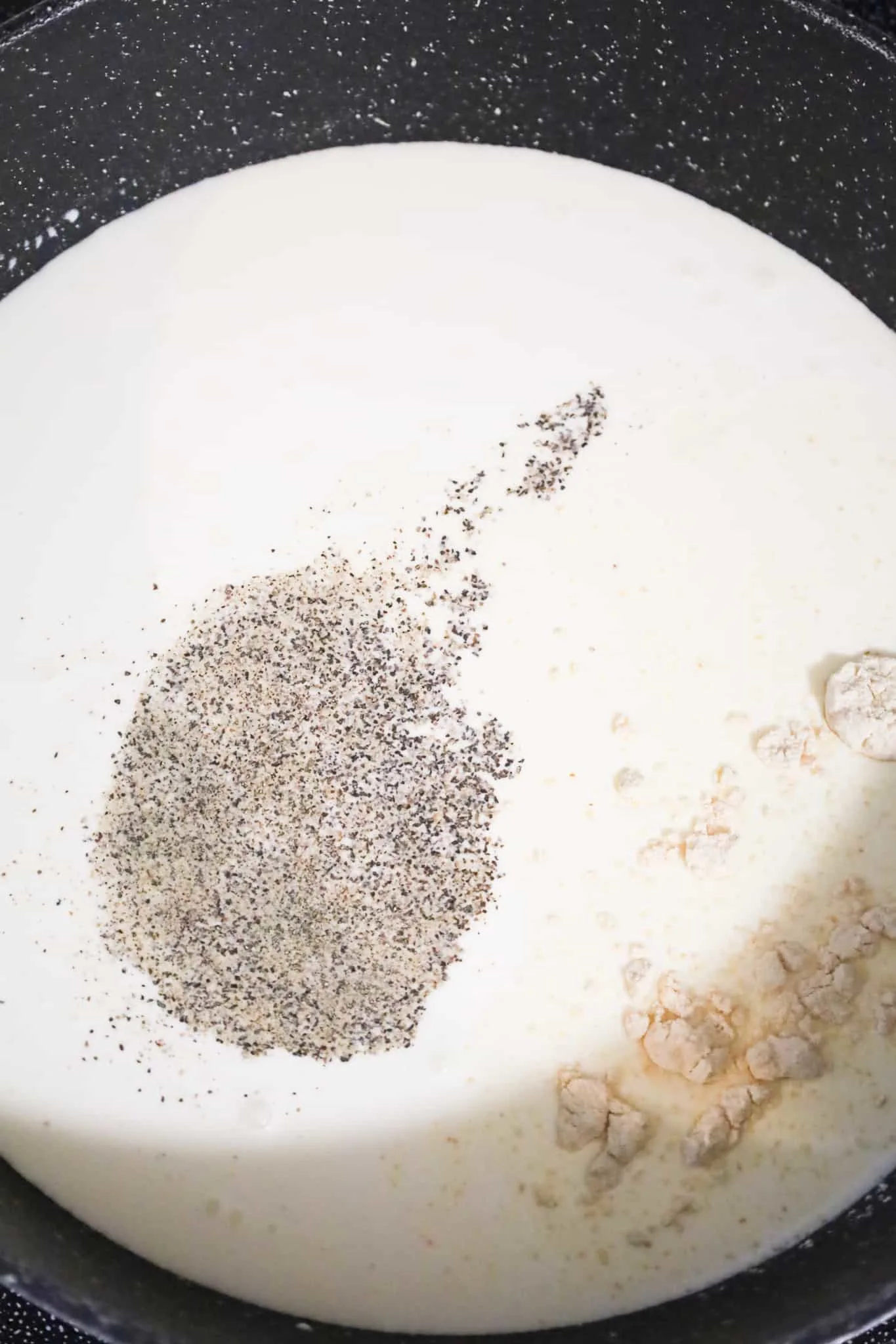 salt, pepper and garlic powder on top of heavy cream in a pot