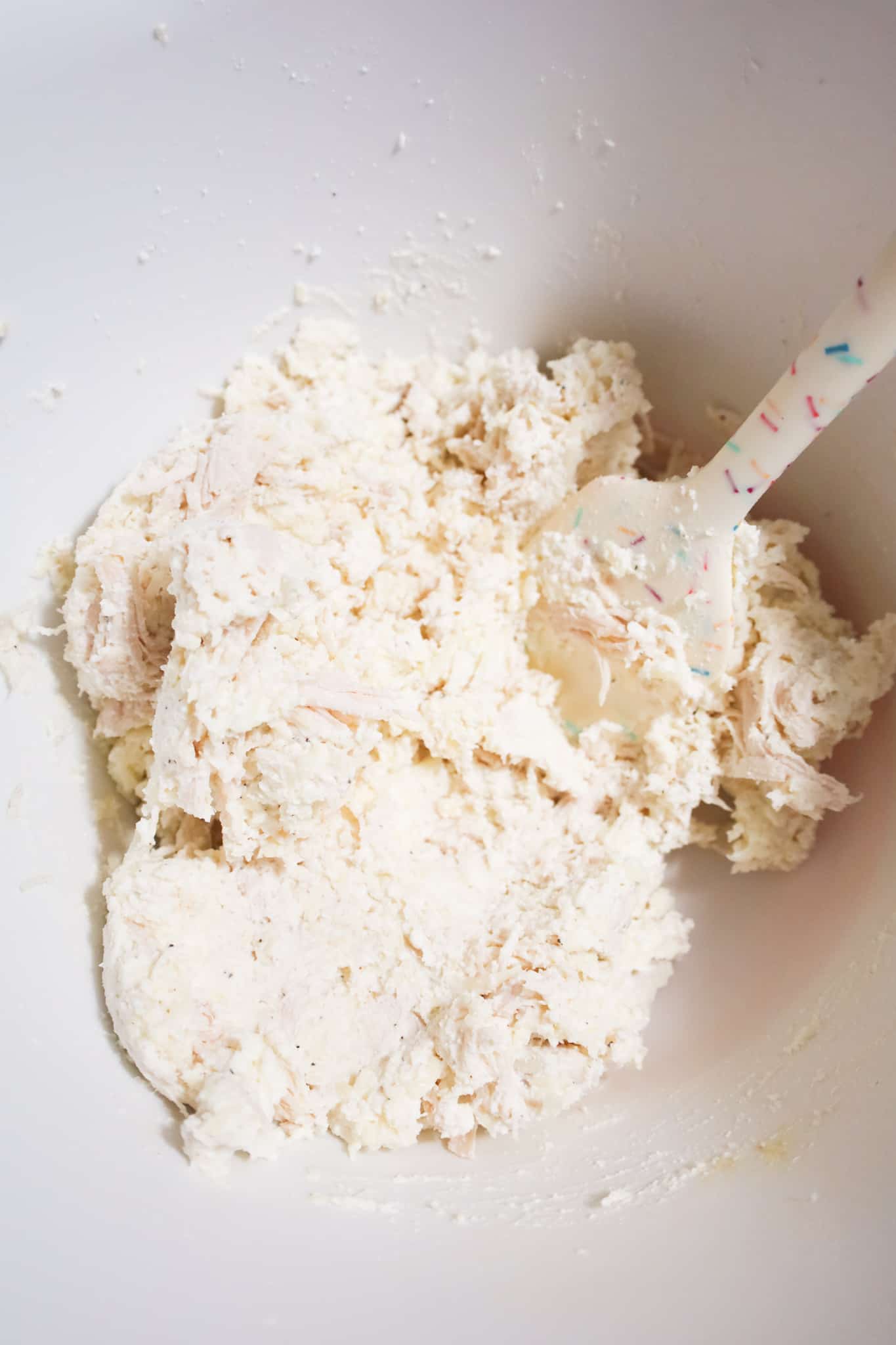 chicken and cheese mixture in a mixing bowl