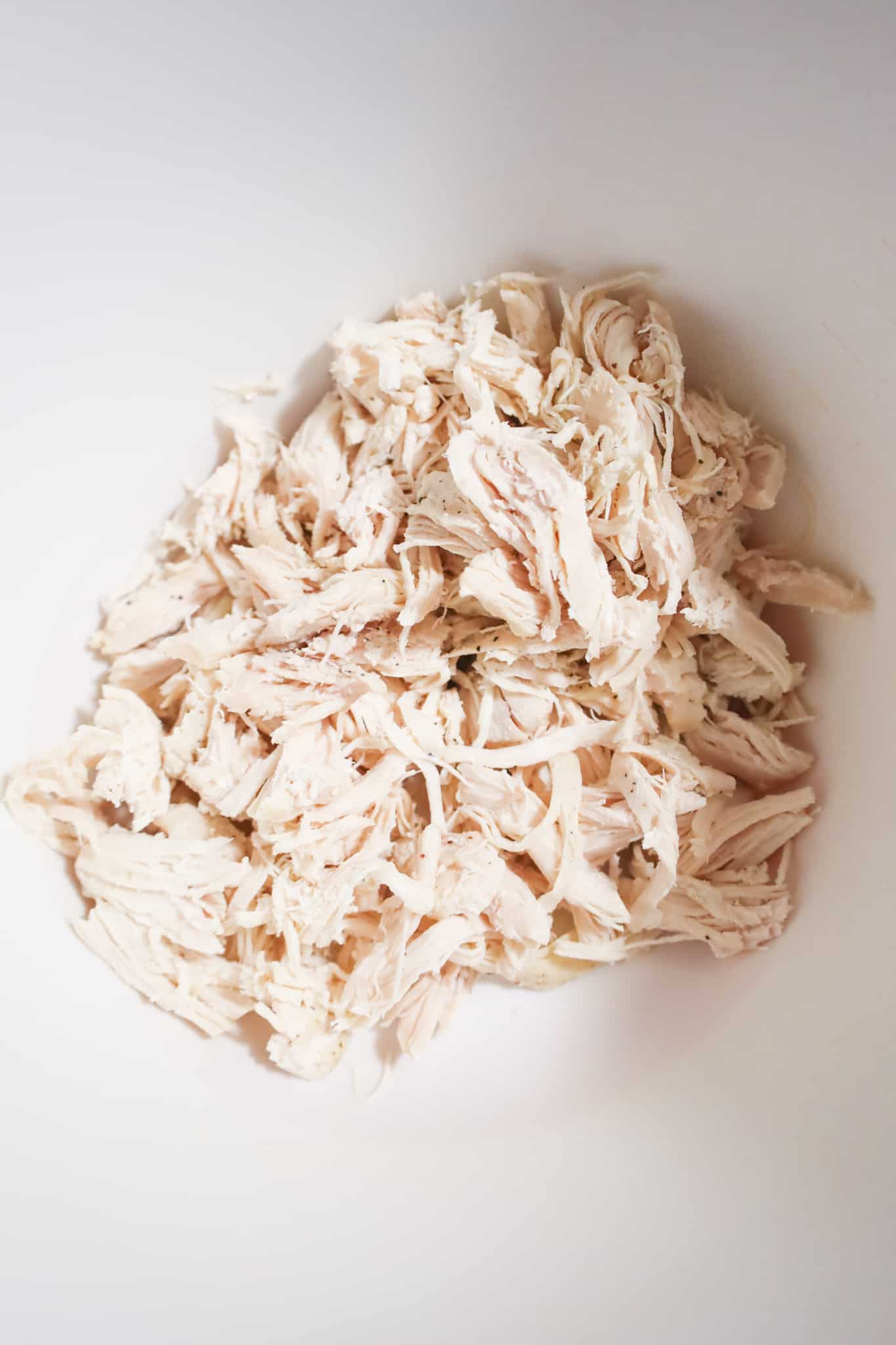shredded chicken in a mixing bowl