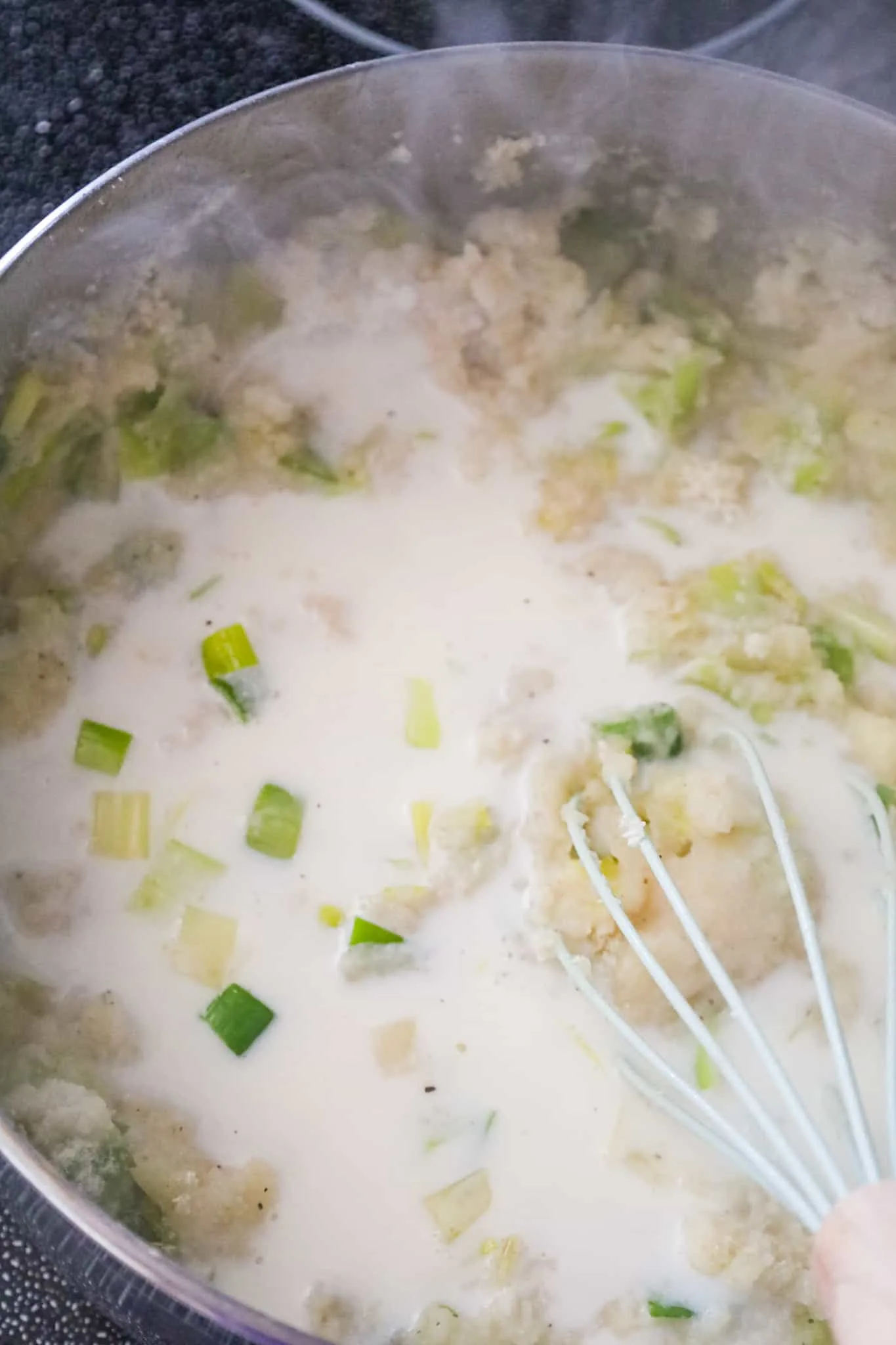 milk added to mashed potato and leek mixture
