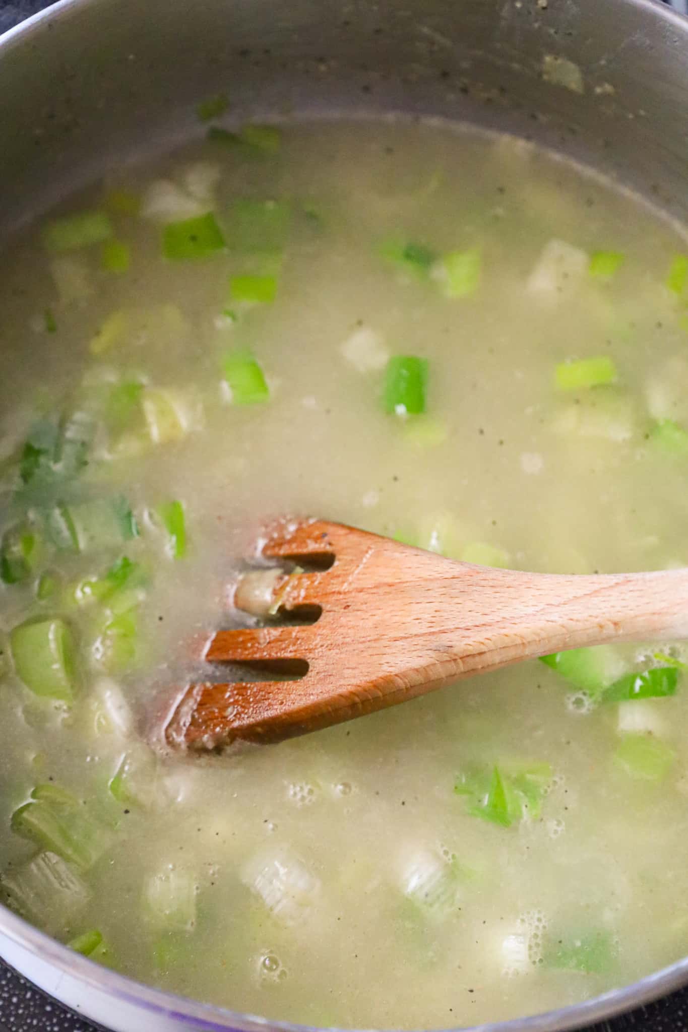 chicken broth and chopped leeks in a large pot