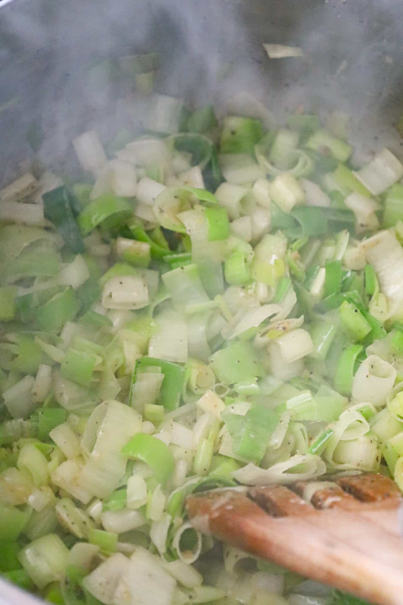 chopped leeks cooking in a large pot