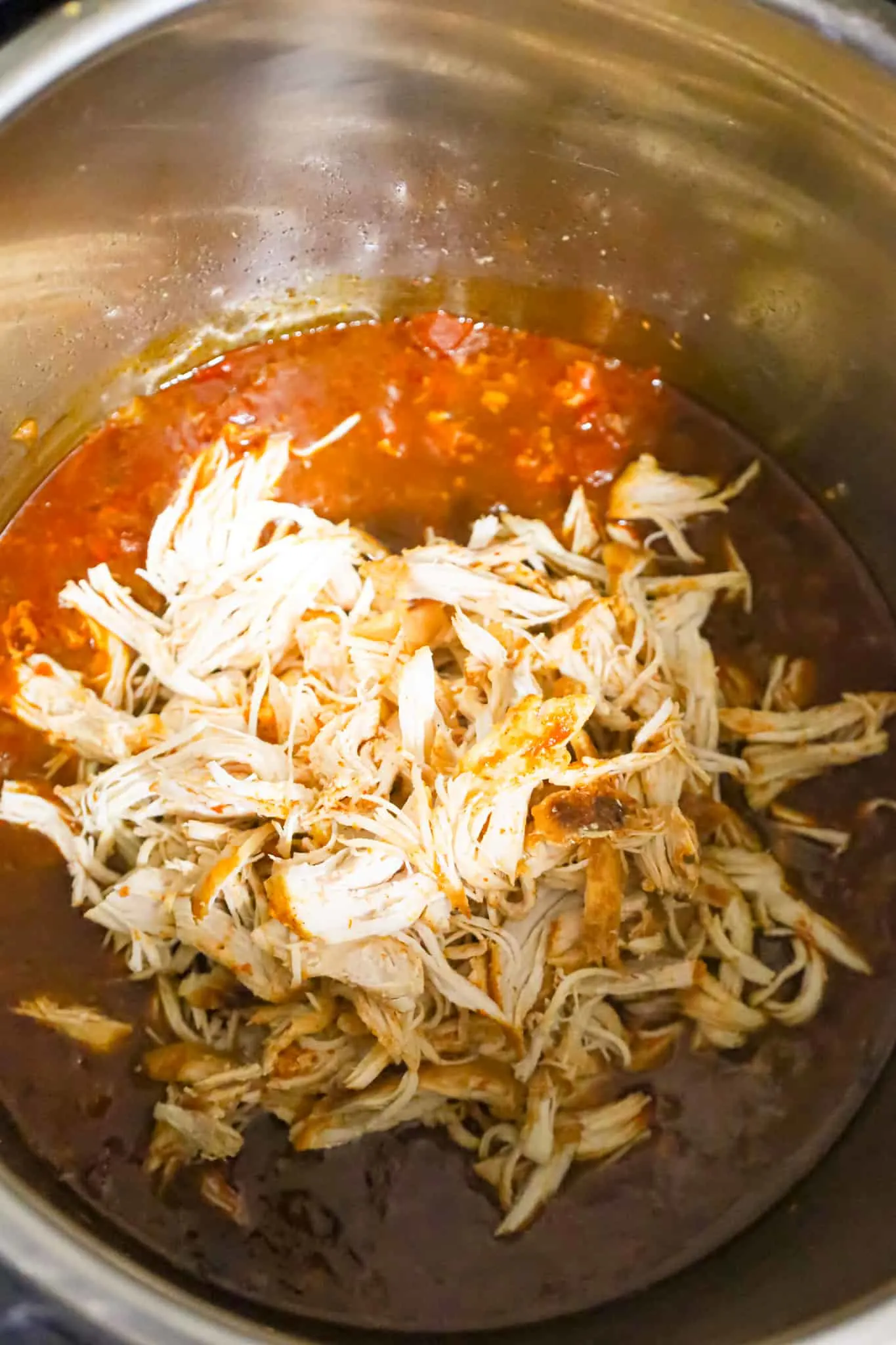 shredded chicken on top of salsa in an Instant Pot