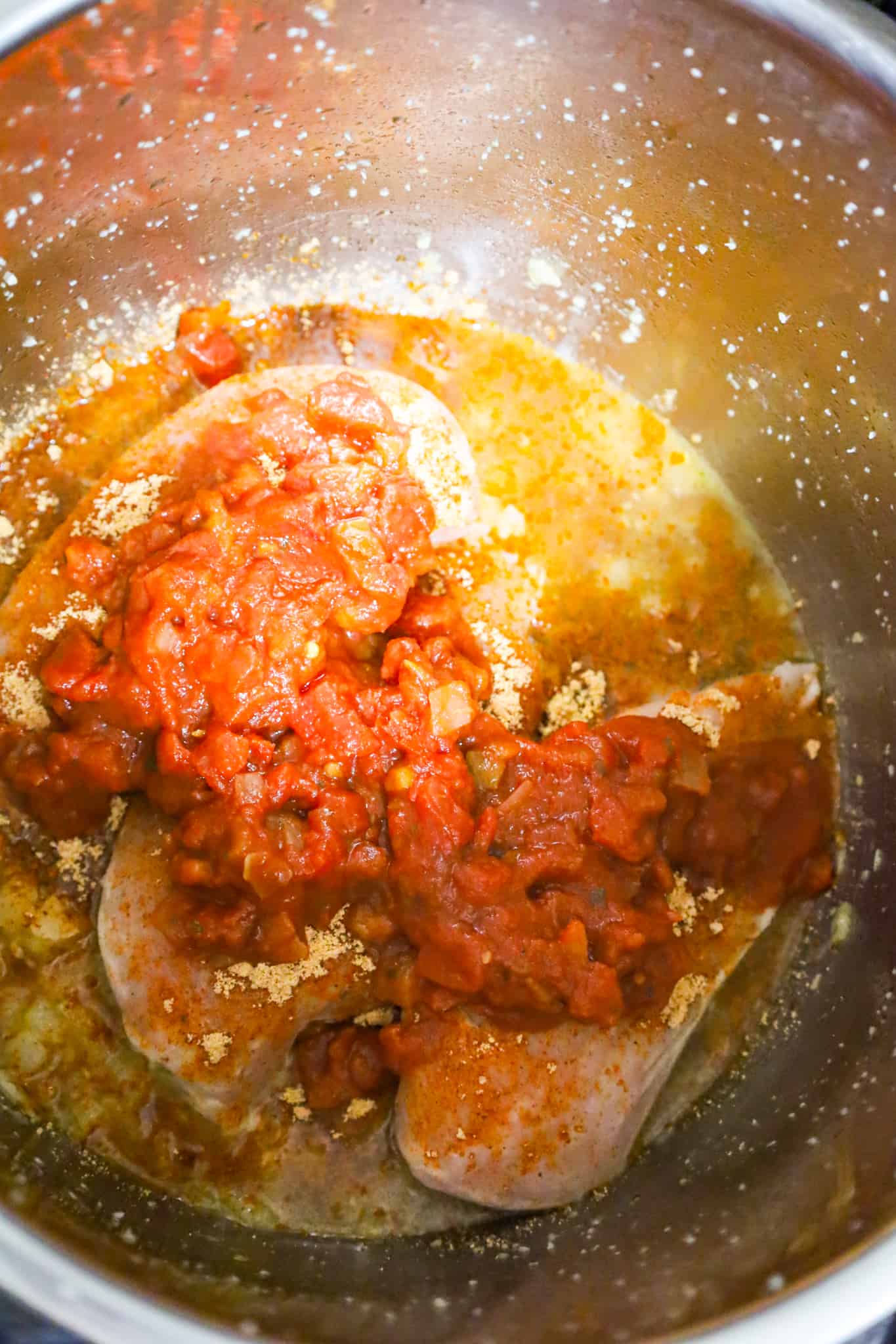 chunky salsa on top of raw chicken breasts in an Instant Pot