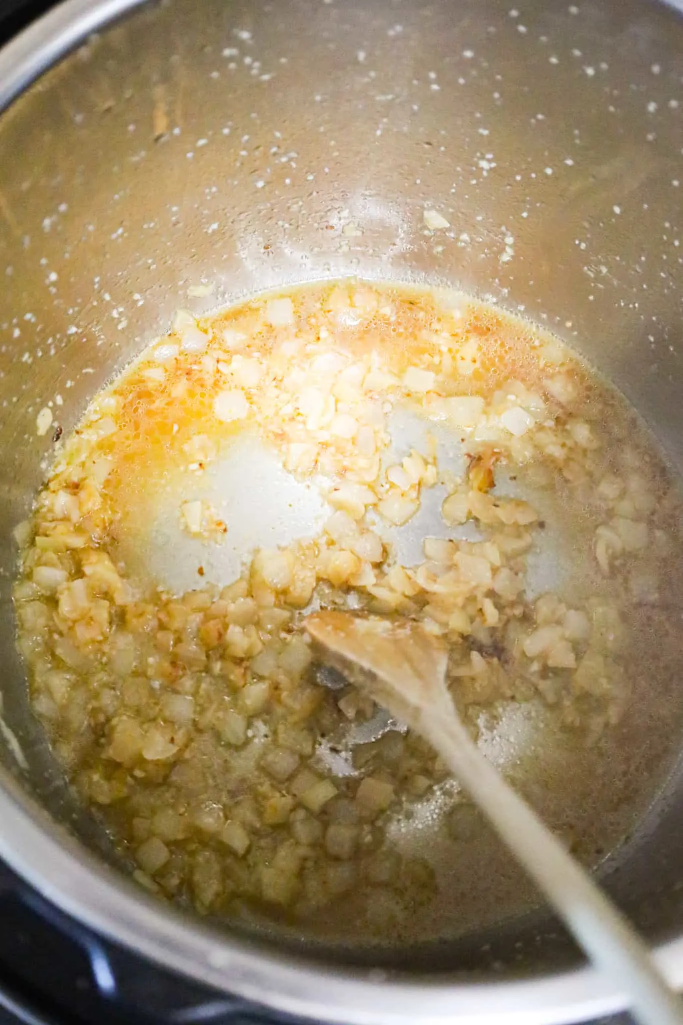 chicken broth added to Instant Pot with cooked diced onions