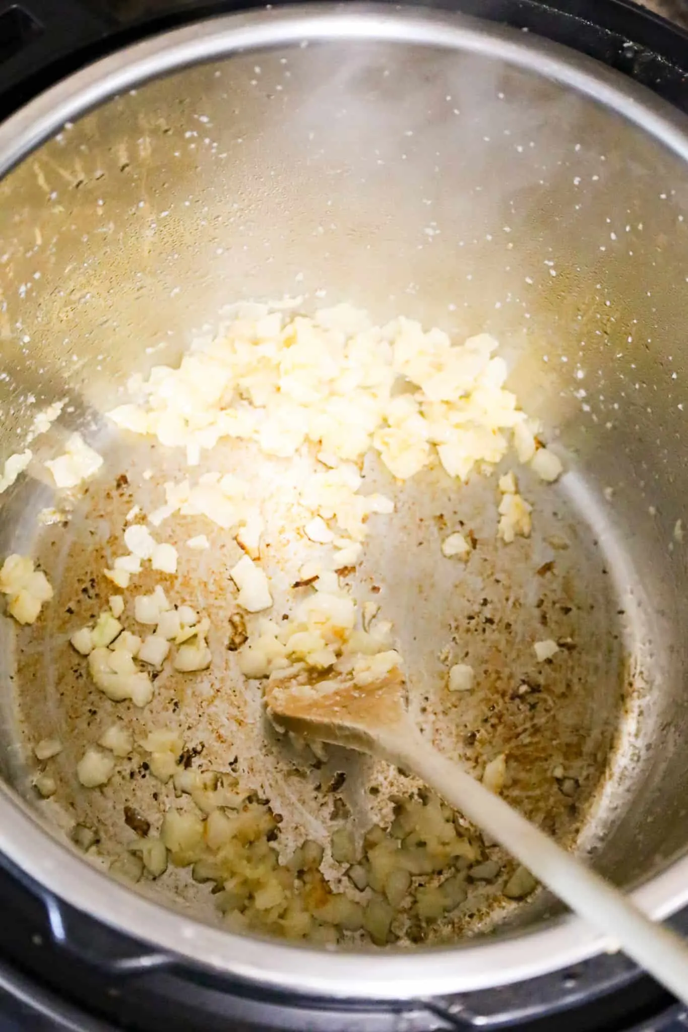 diced onions cooking in an Instant Pot