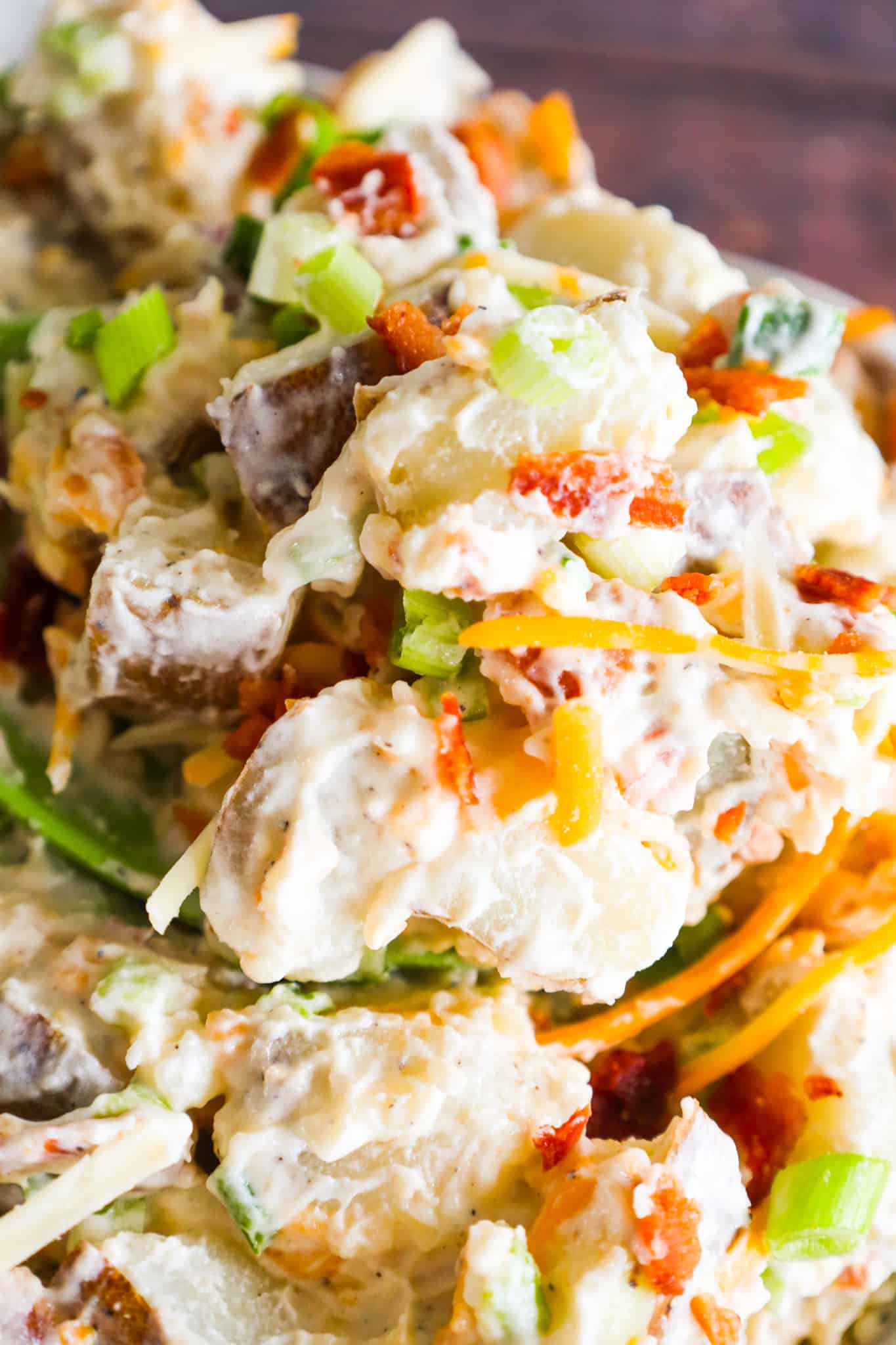 Loaded Baked Potato Salad is a delicious cold side dish recipe made with russet potatoes and loaded with mayo, sour cream, crumbled bacon, cheddar cheese and chopped green onions.